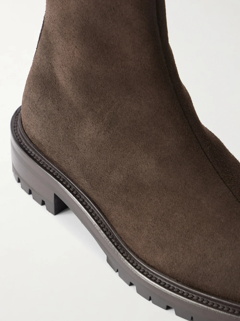 Close-up detail of The Row Moto Suede Ankle Boots