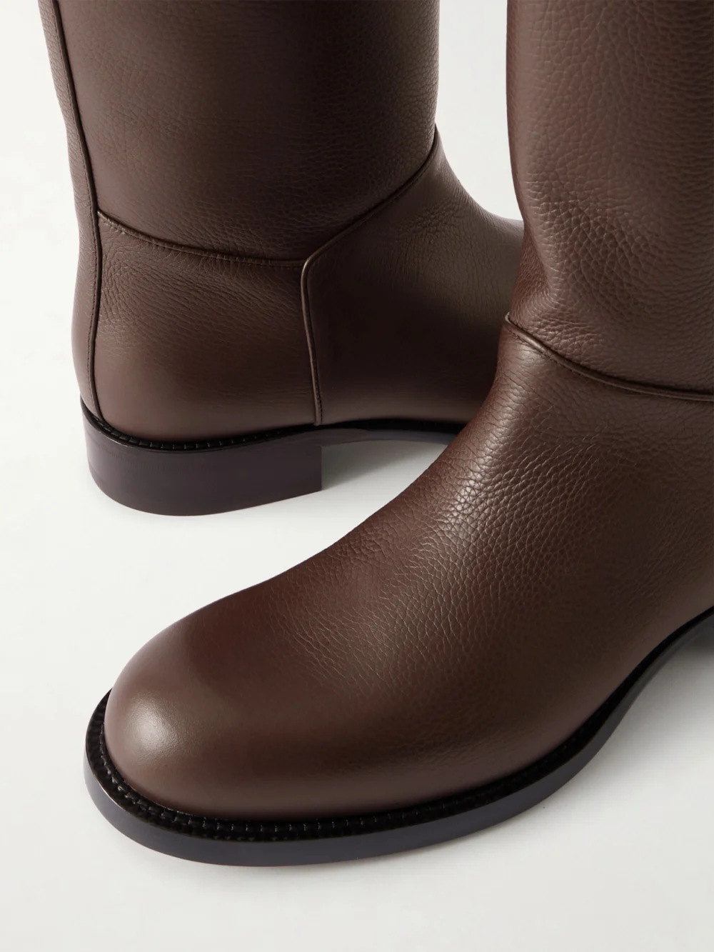 Close-up detail of The Row Nobilis Textured-leather Ankle Boots