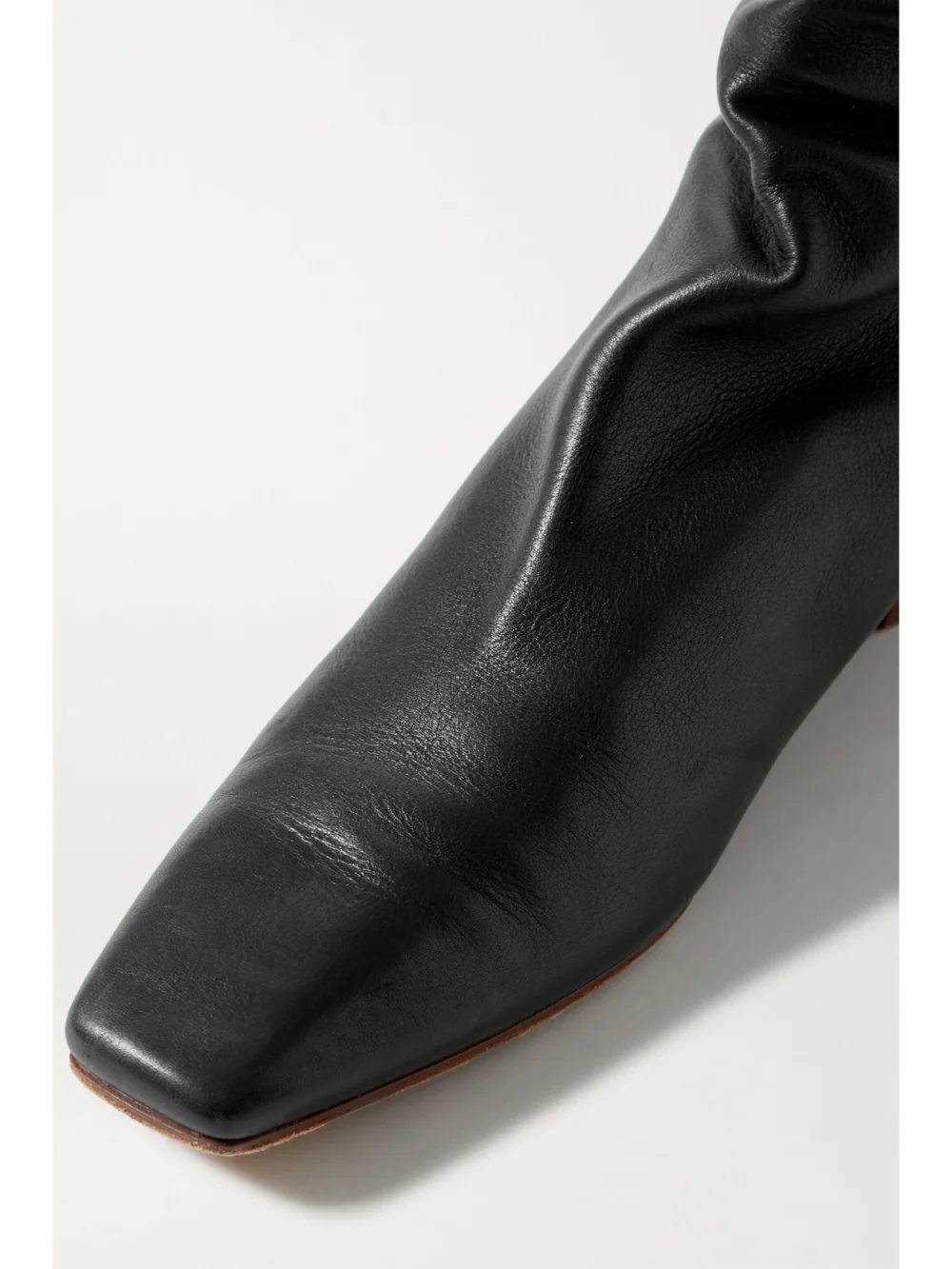 Close-up detail of The Row Slouchy Leather Knee Boots