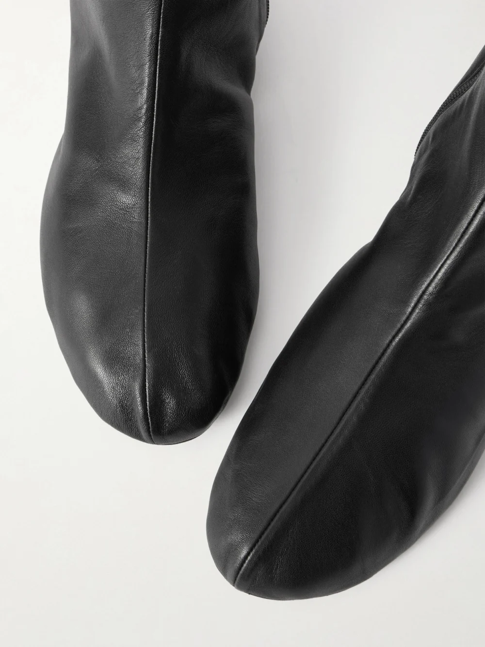 Close-up detail of The Row Stella Leather and Shearling Ankle Boots
