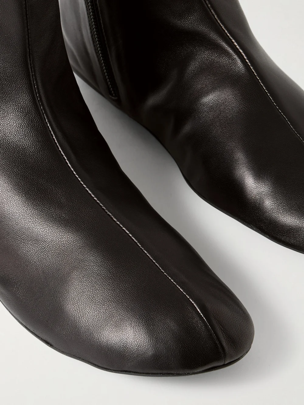 Close-up detail of The Row Stella Leather and Shearling Ankle Boots