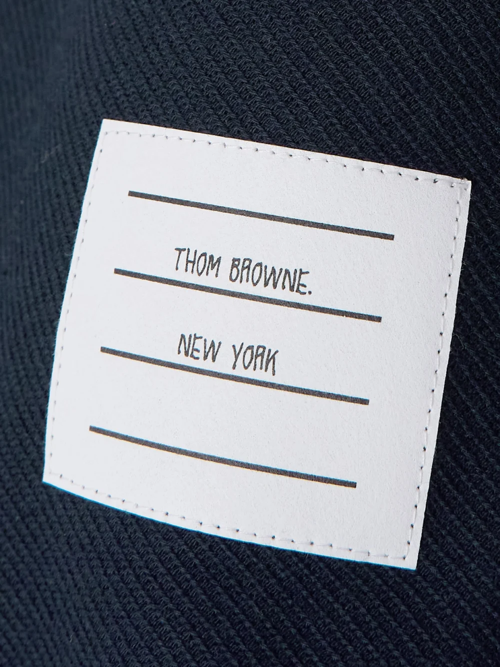 Close-up detail of the Thom Browne Appliquéd Two-tone Cotton-twill Mini Skirt