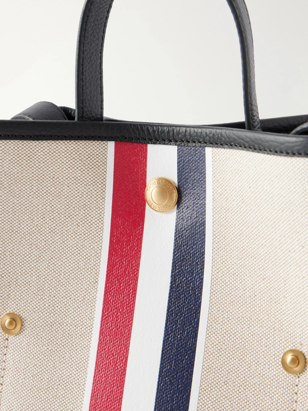 Close-up detail of the Thom Browne Striped Leather-trimmed Canvas Bucket Bag