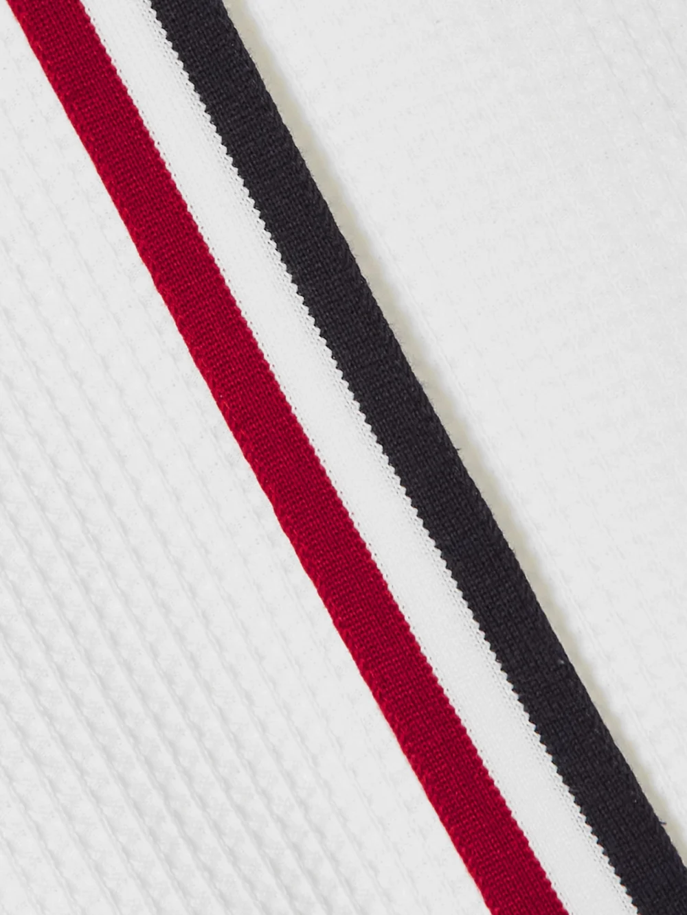 Close-up detail of the Thom Browne Wrap-effect Striped Waffle-knit Cotton Mini Skirt