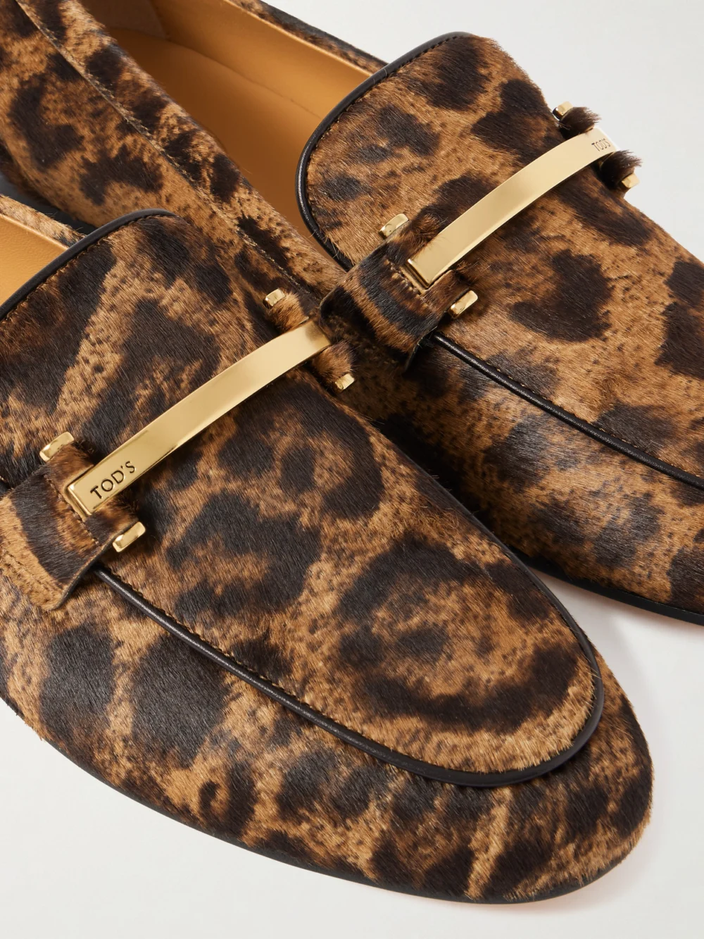 Close-up detail of the Tod's Embellished Leopard-print Calf Hair Loafers