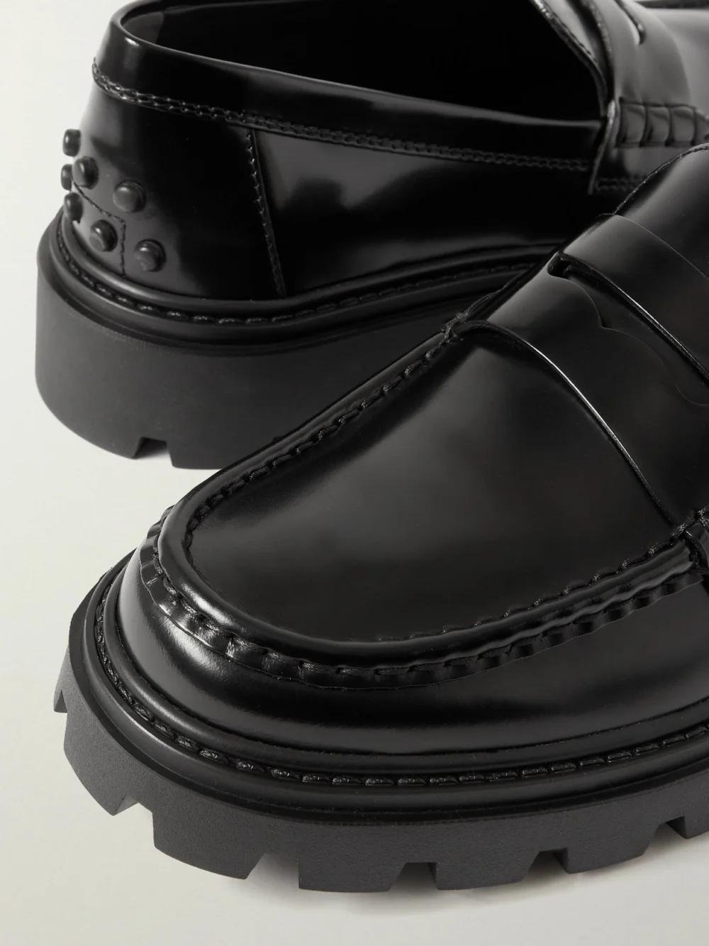Close-up detail of the Tod's Gomma Pesante Glossed-leather Loafers