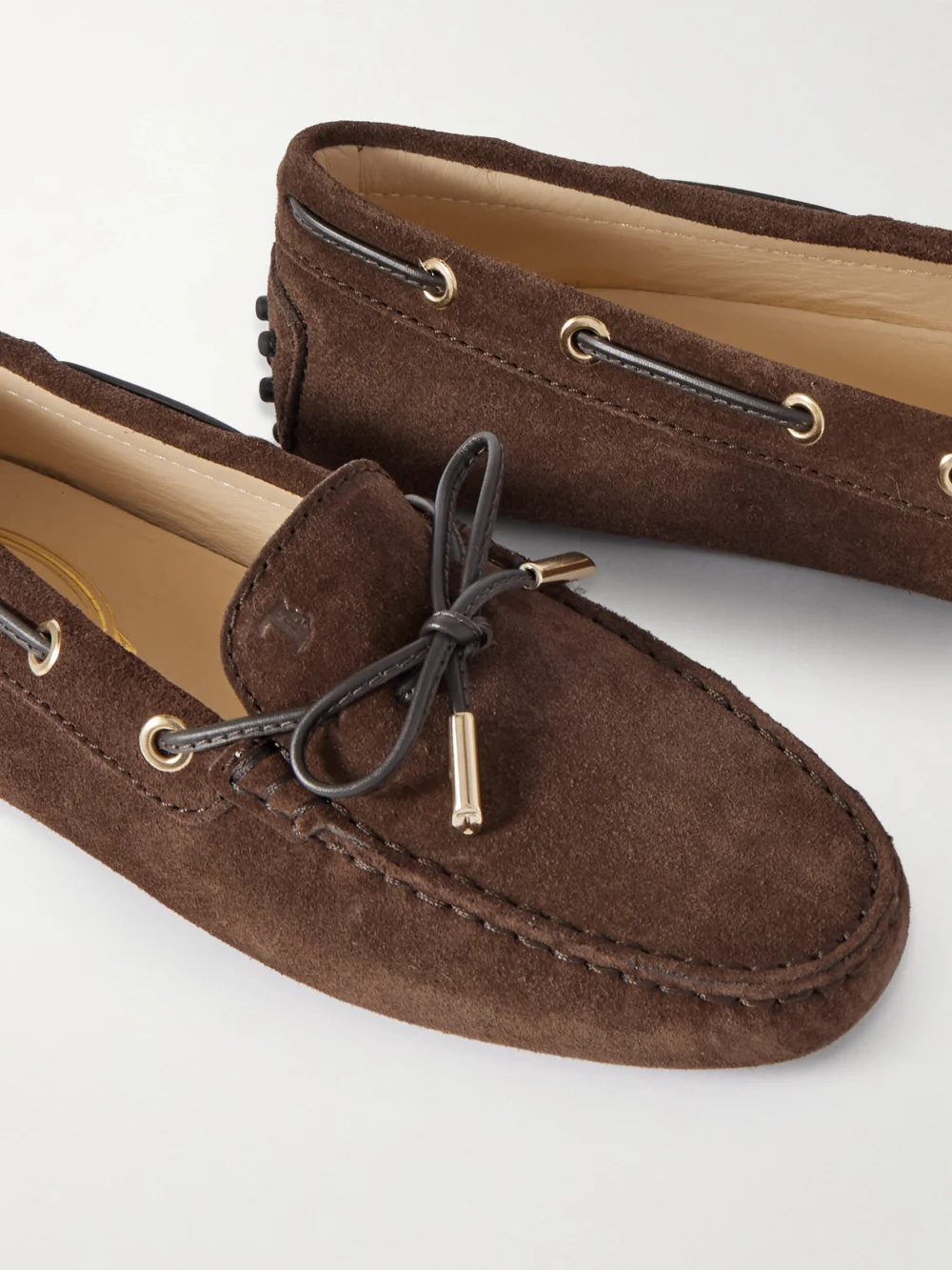 Close-up detail of the Tod's Gommino Leather-trimmed Suede Loafers