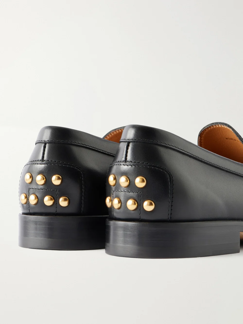 Close-up detail of the Tod's Logo-debossed Studded Leather Loafers