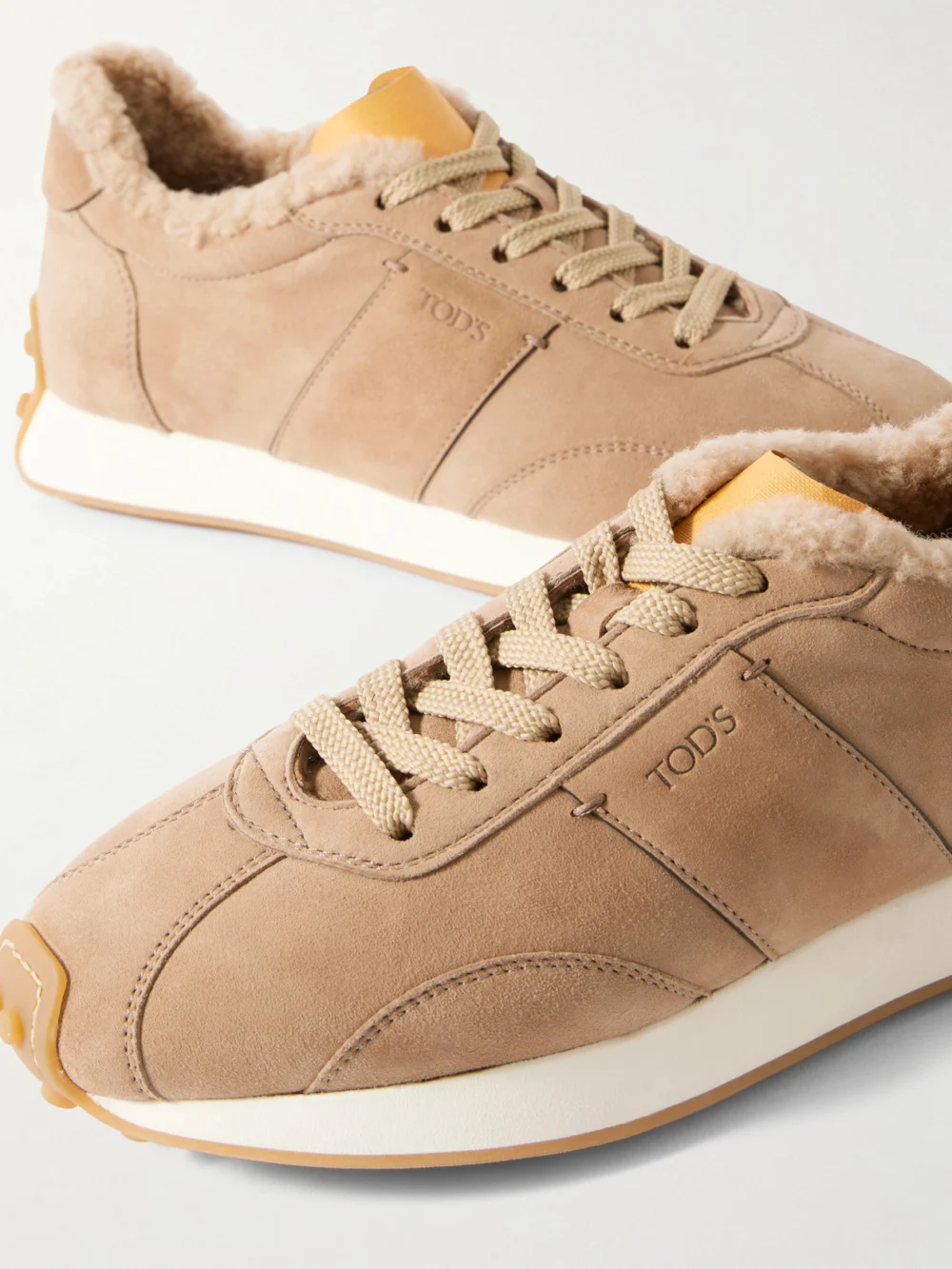 Close-up detail of the Tod's Sportivo Active Embroidered Shearling-trimmed Suede Sneakers