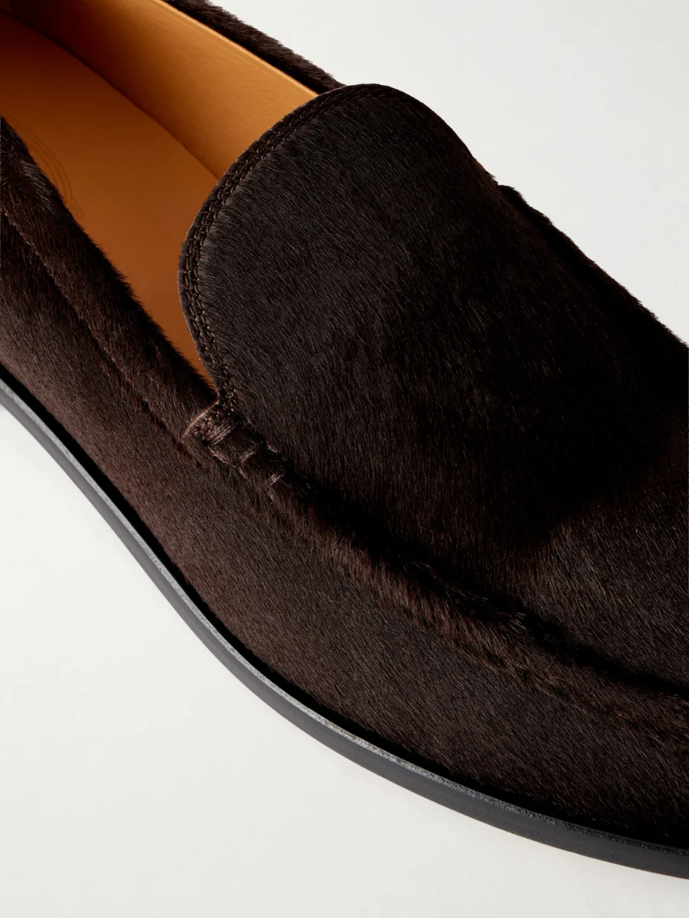 Close-up detail of the Tod's Studded Calf Hair Loafers