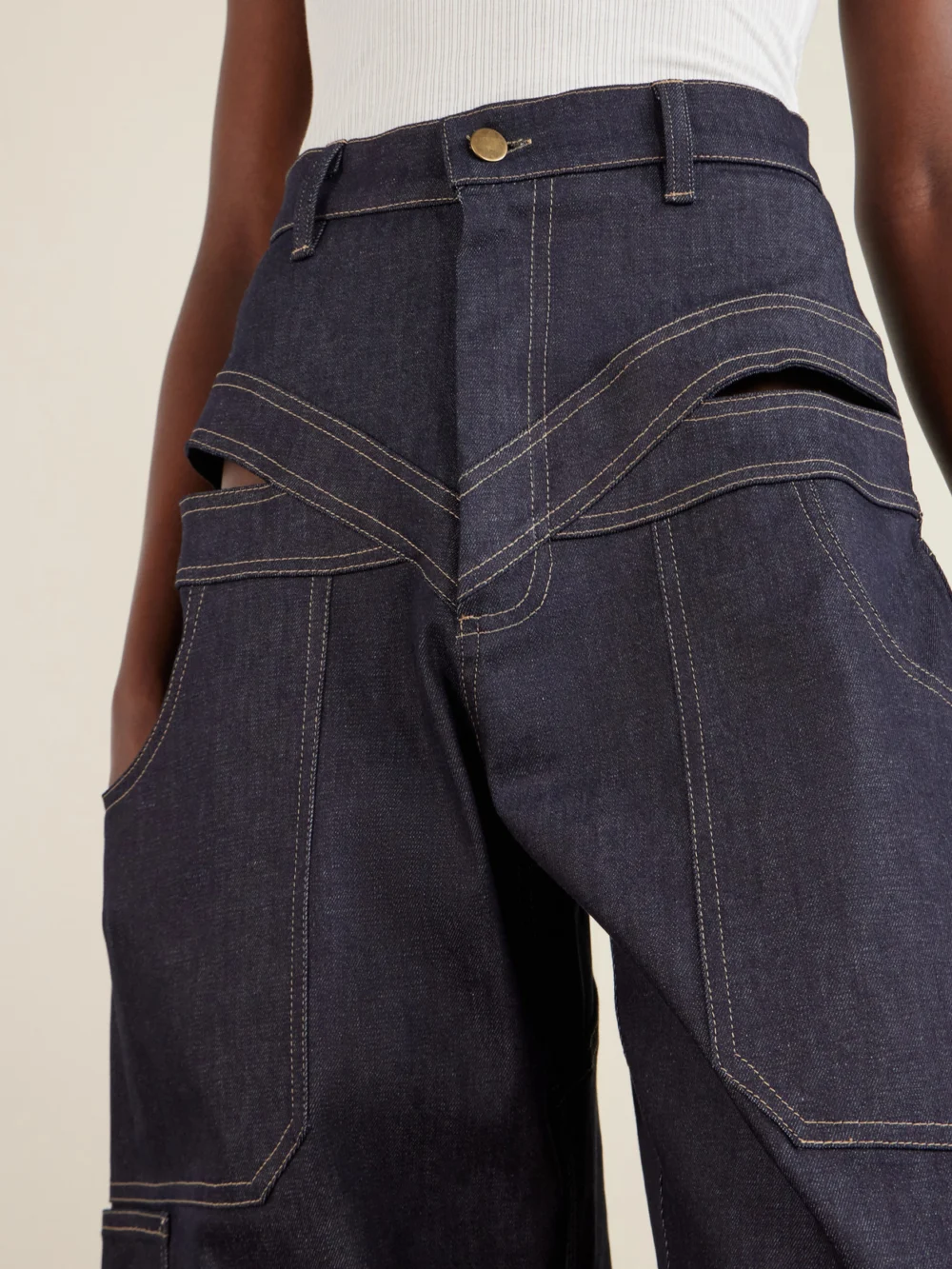 Close-up detail of the Tolu Coker Banana Cutout High-rise Barrel-leg Jeans