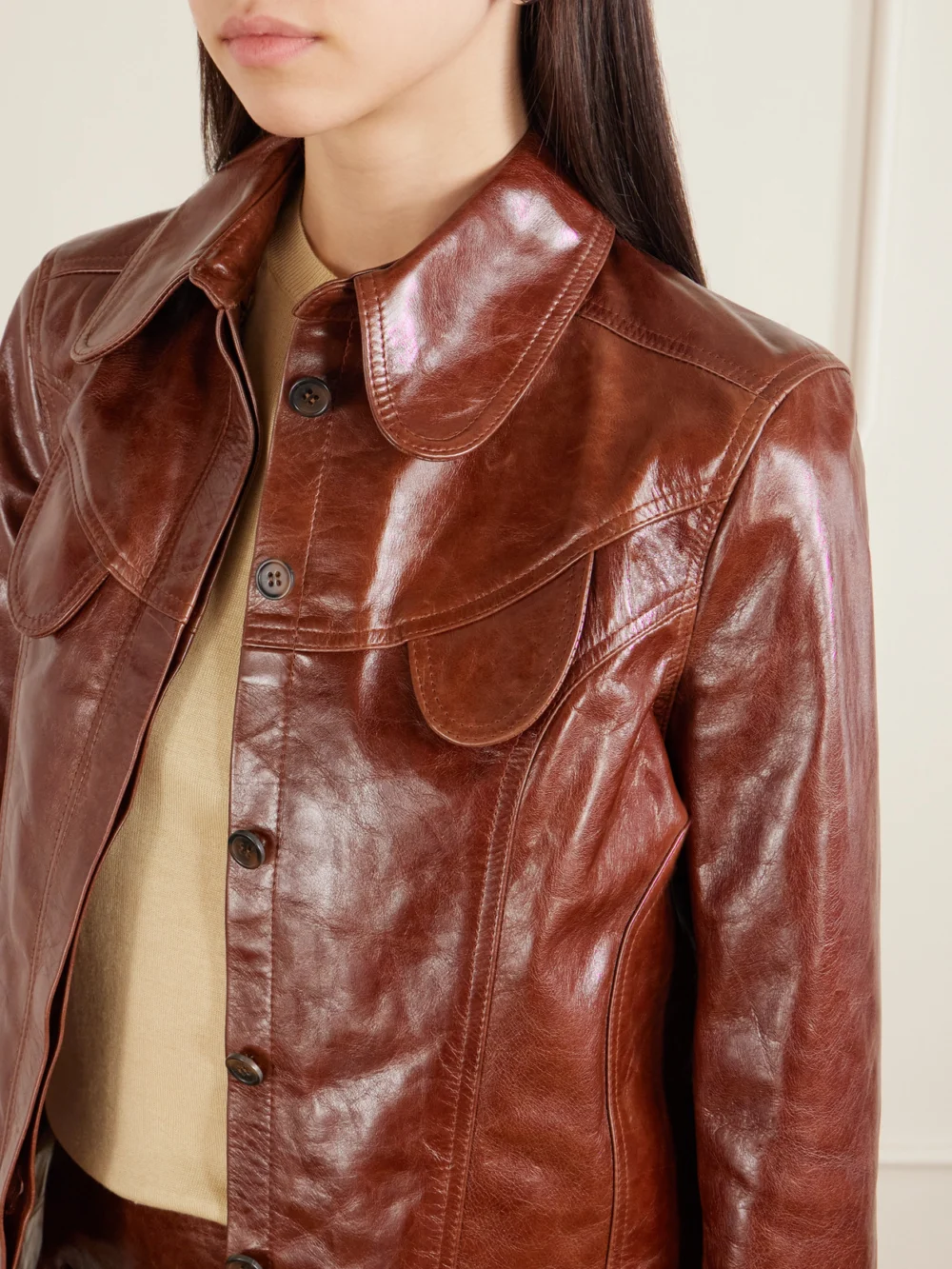 Close-up detail of the Tolu Coker Paneled Glossed-leather Jacket