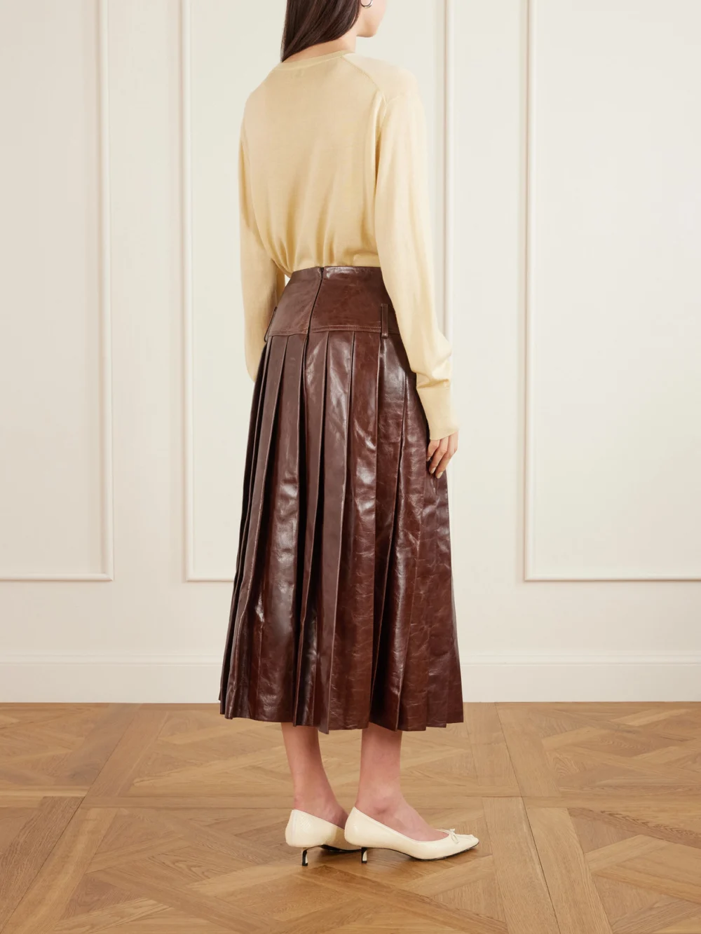 Back view of the Tolu Coker Pleated Glossed-leather Midi Skirt