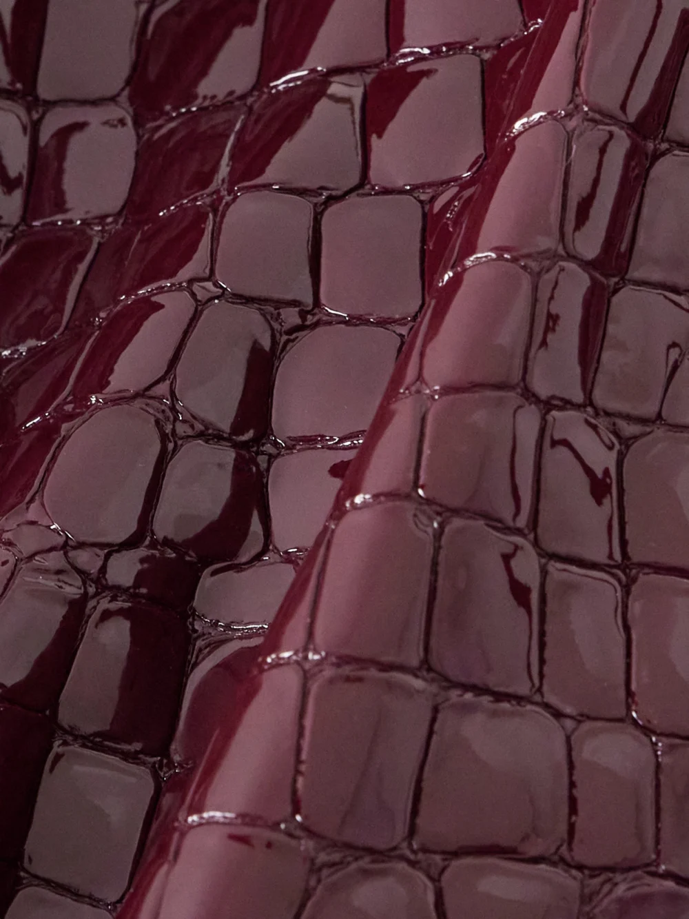 Close-up detail of the Tom Ford Croc-effect Patent-leather Skirt