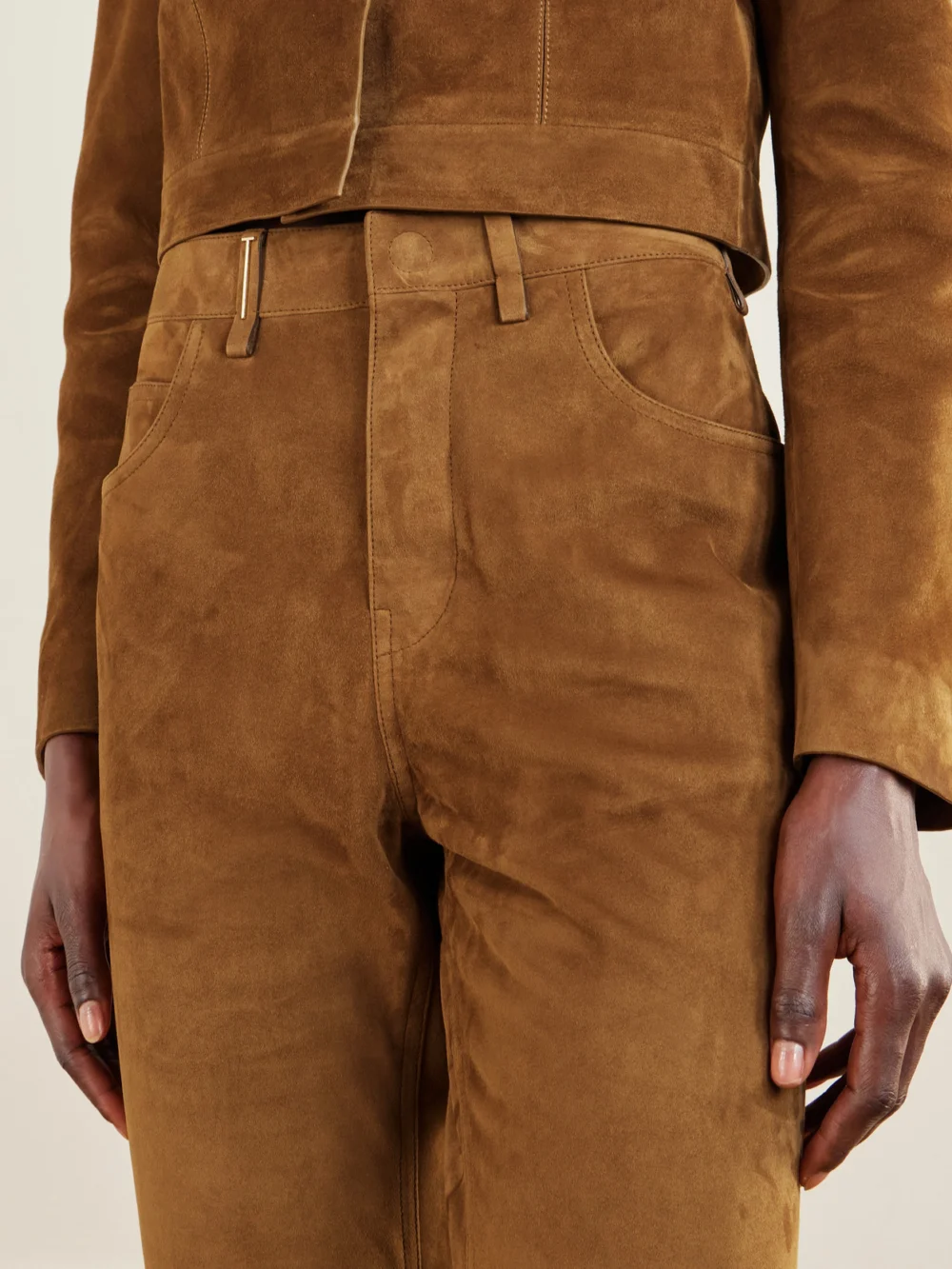 Close-up detail of the Tom Ford Embellished Paneled Suede Straight-leg Pants