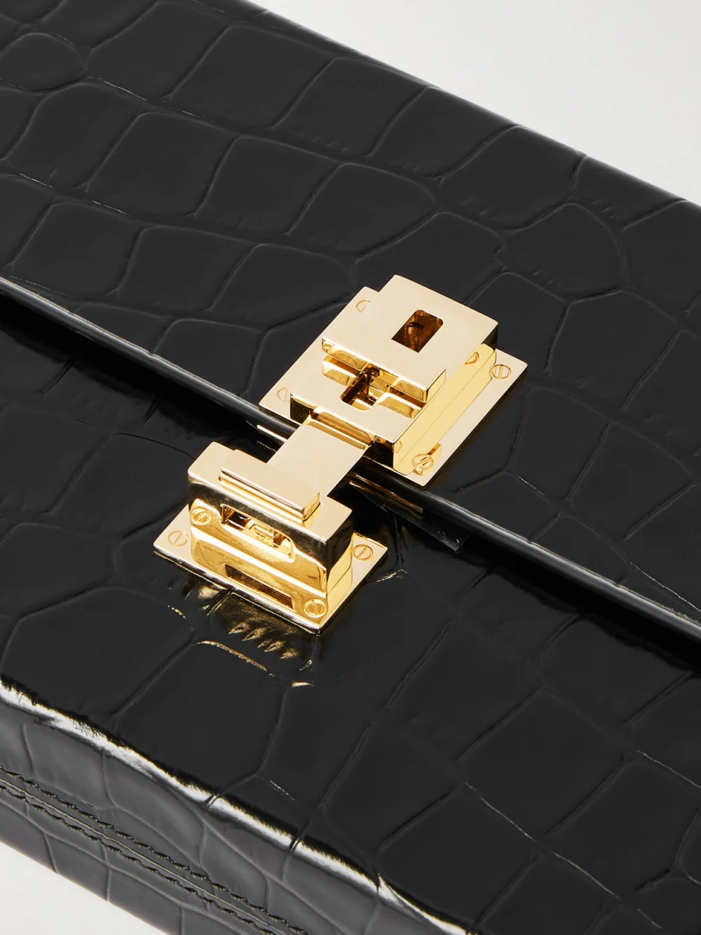 Close-up detail of the Tom Ford Glossed Croc-effect Leather Clutch