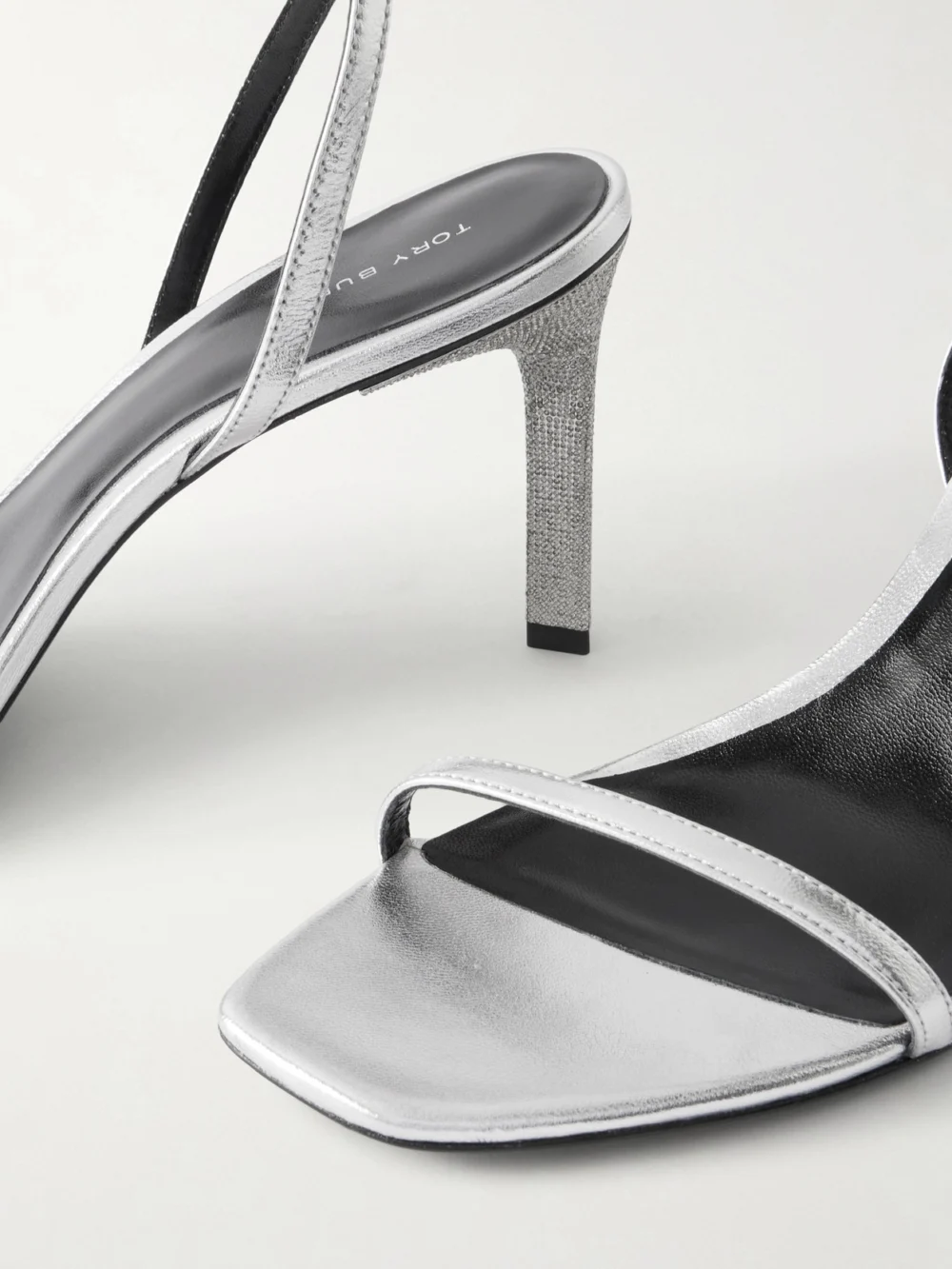 Close-up detail of the Tory Burch Crystal-embellished Metallic Leather Sandals