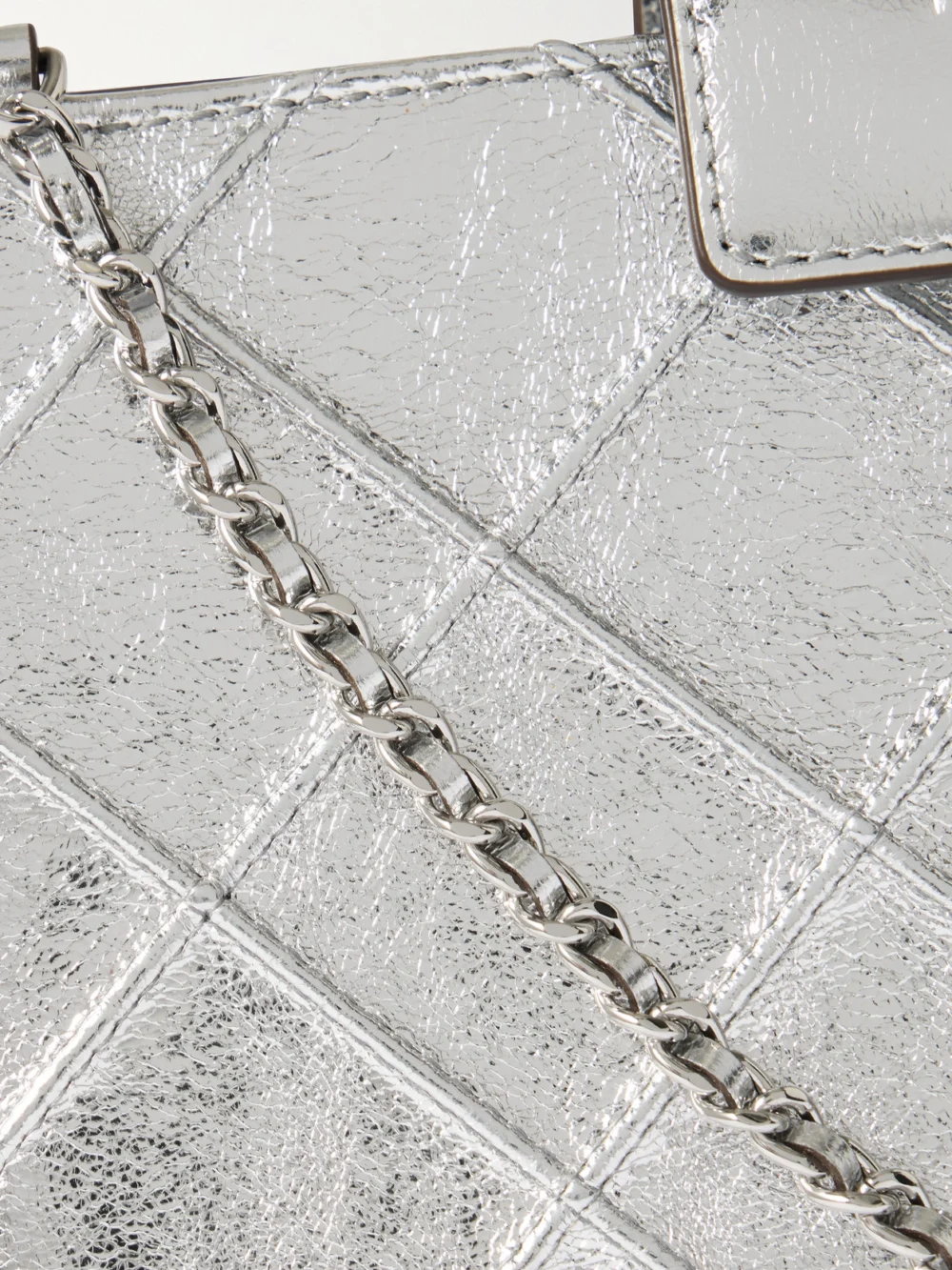 Close-up detail of the Tory Burch Fleming Mini Quilted Metallic Leather Shoulder Bag