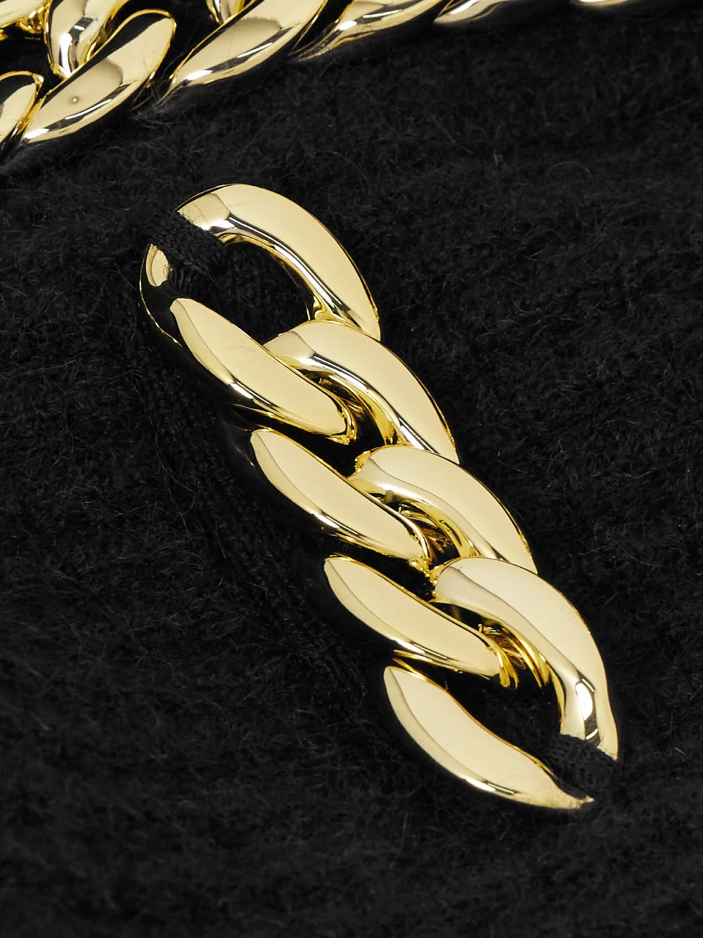 Close-up detail of the Tory Burch Kendra Chain-embellished Waffle-knit Cardigan