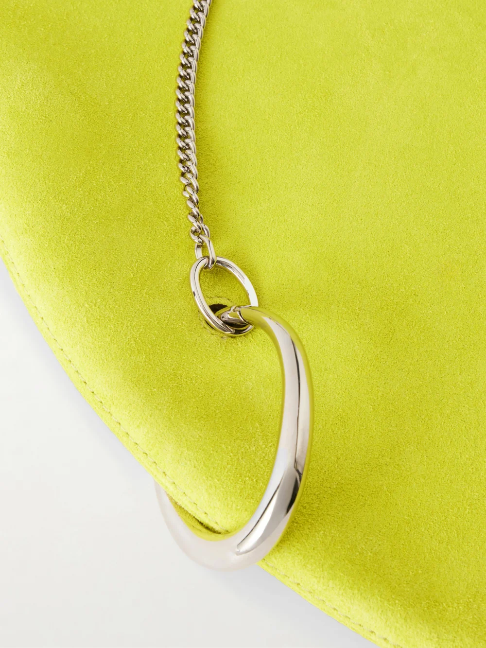 Close-up detail of the Tory Burch Pierced Embellished Suede Shoulder Bag