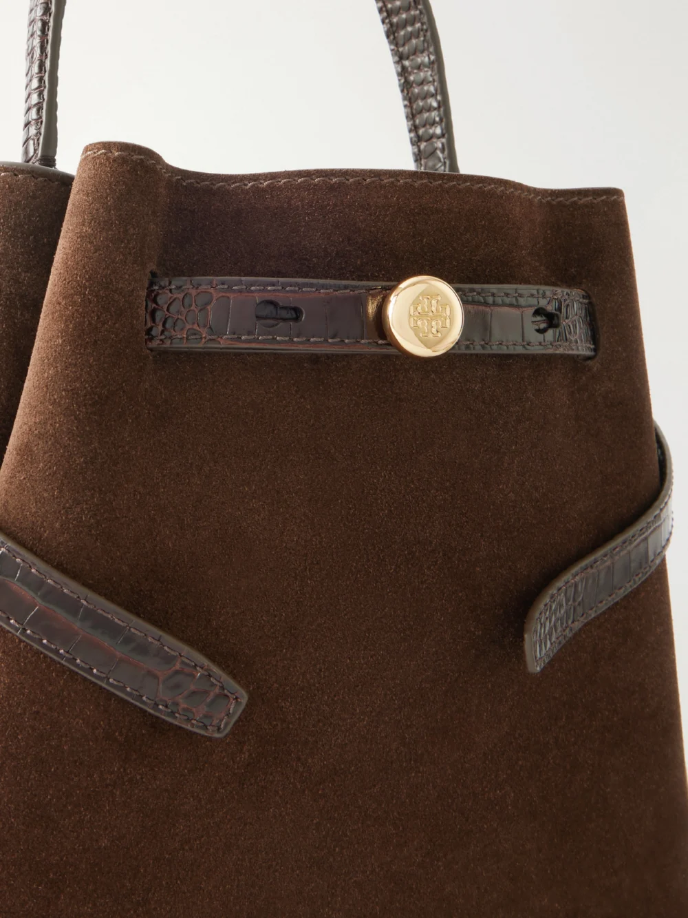 Close-up detail of the Tory Burch Romy Leather-trimmed Suede Bucket Bag