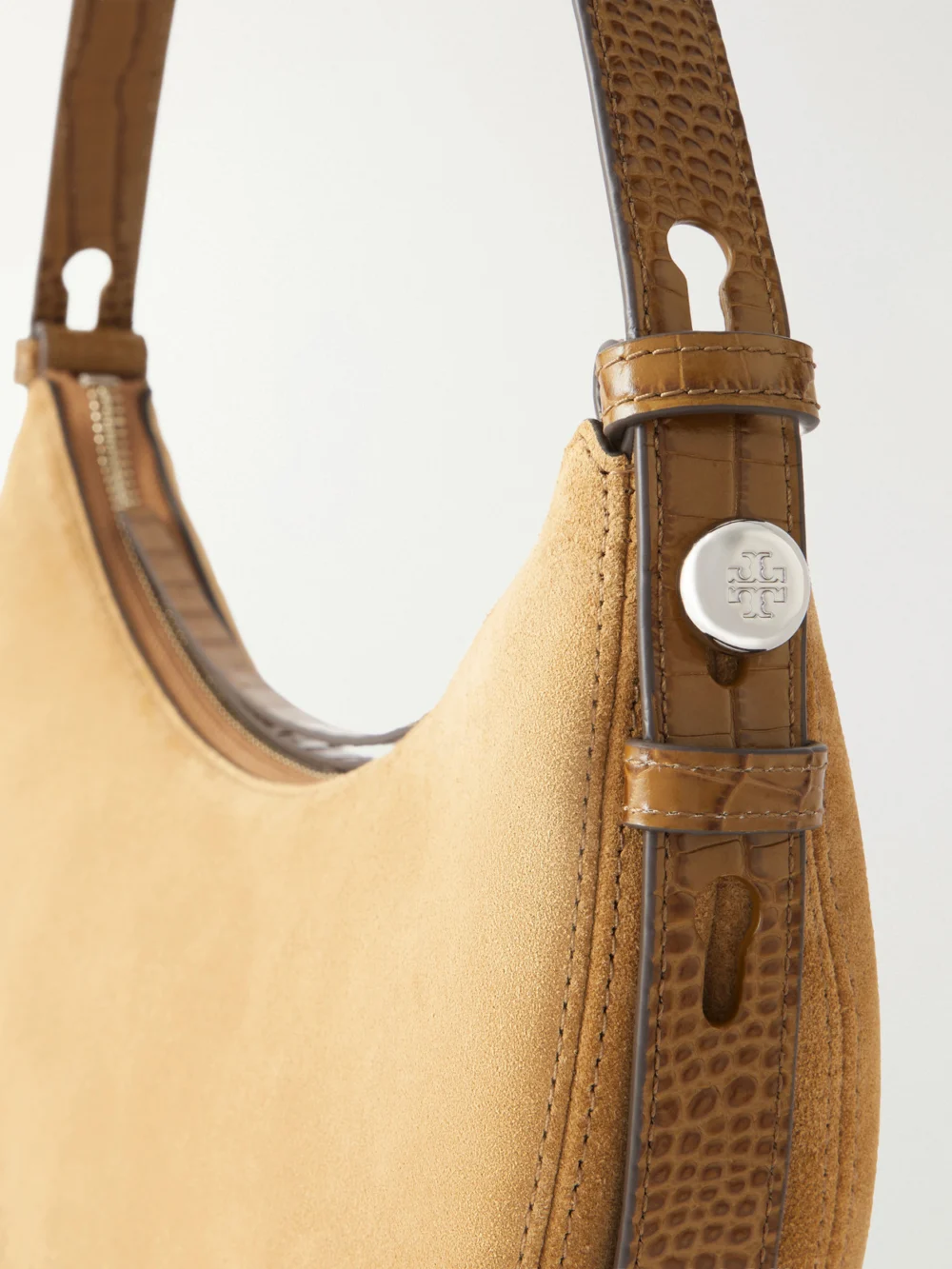 Close-up detail of the Tory Burch Romy Leather-trimmed Suede Shoulder Bag