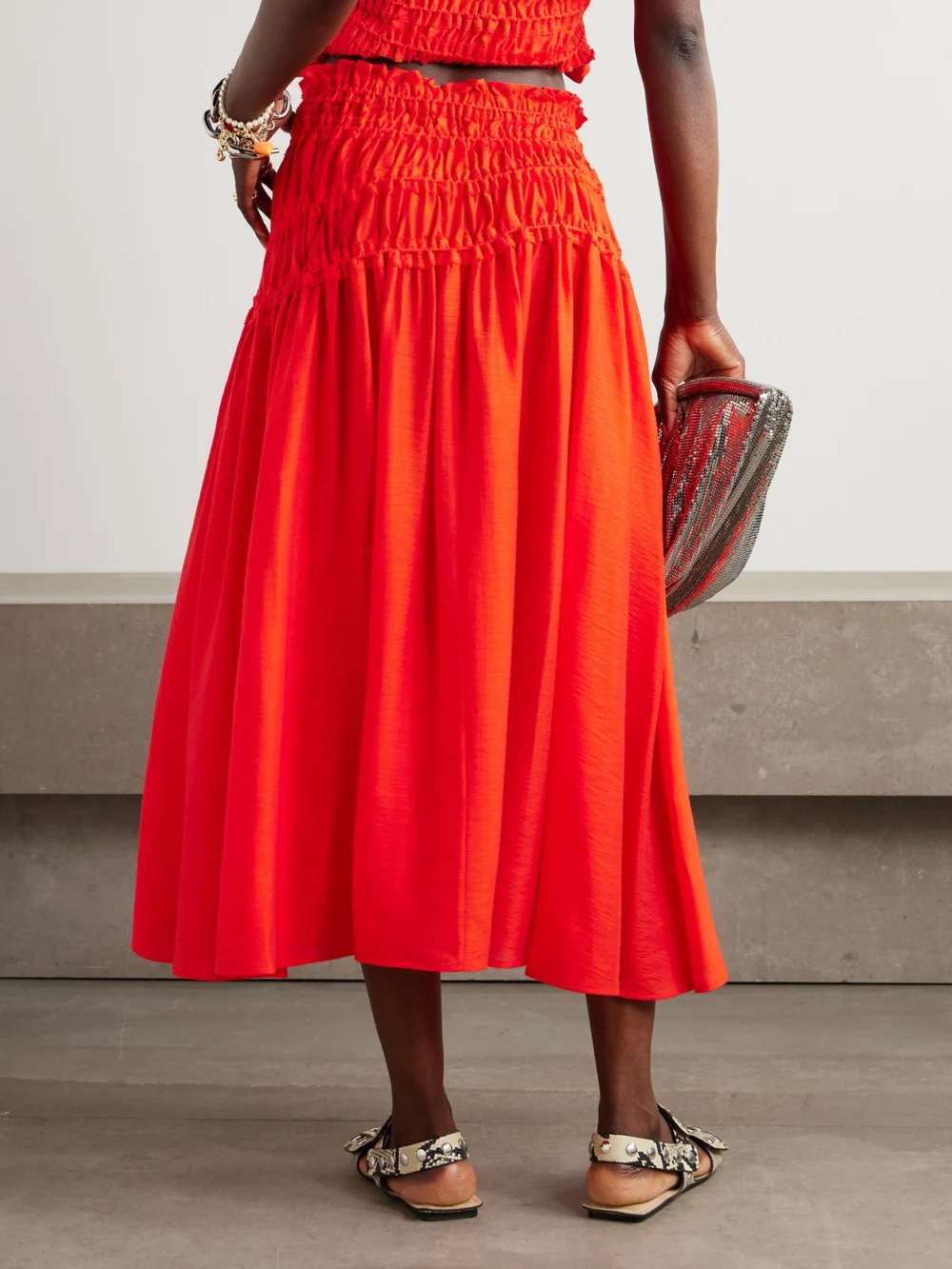 Back view of the Tory Burch Ruffled Shirred Lyocell-blend Midi Skirt