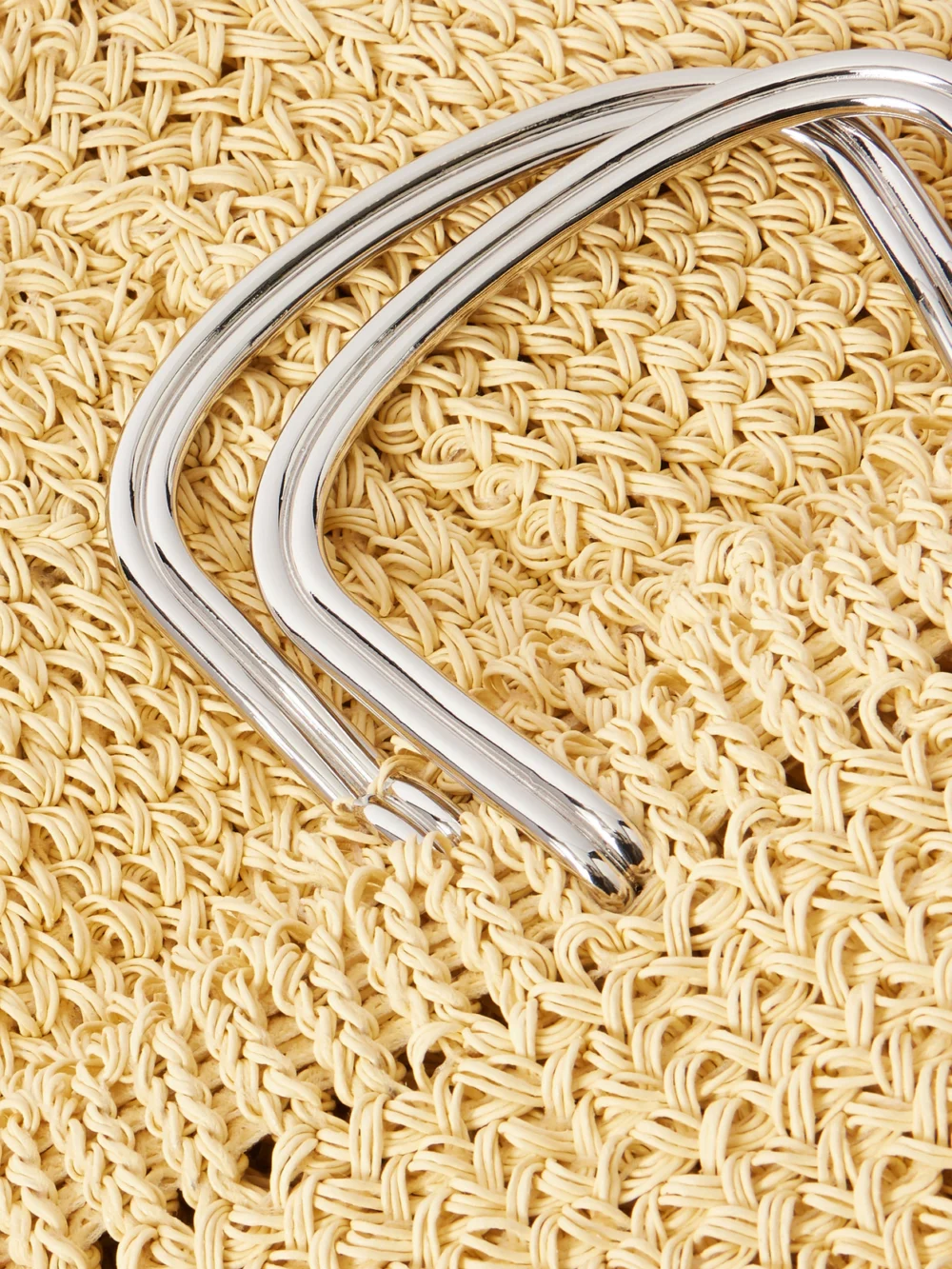 Close-up detail of the Tory Burch Woven Raffia Tote Bag