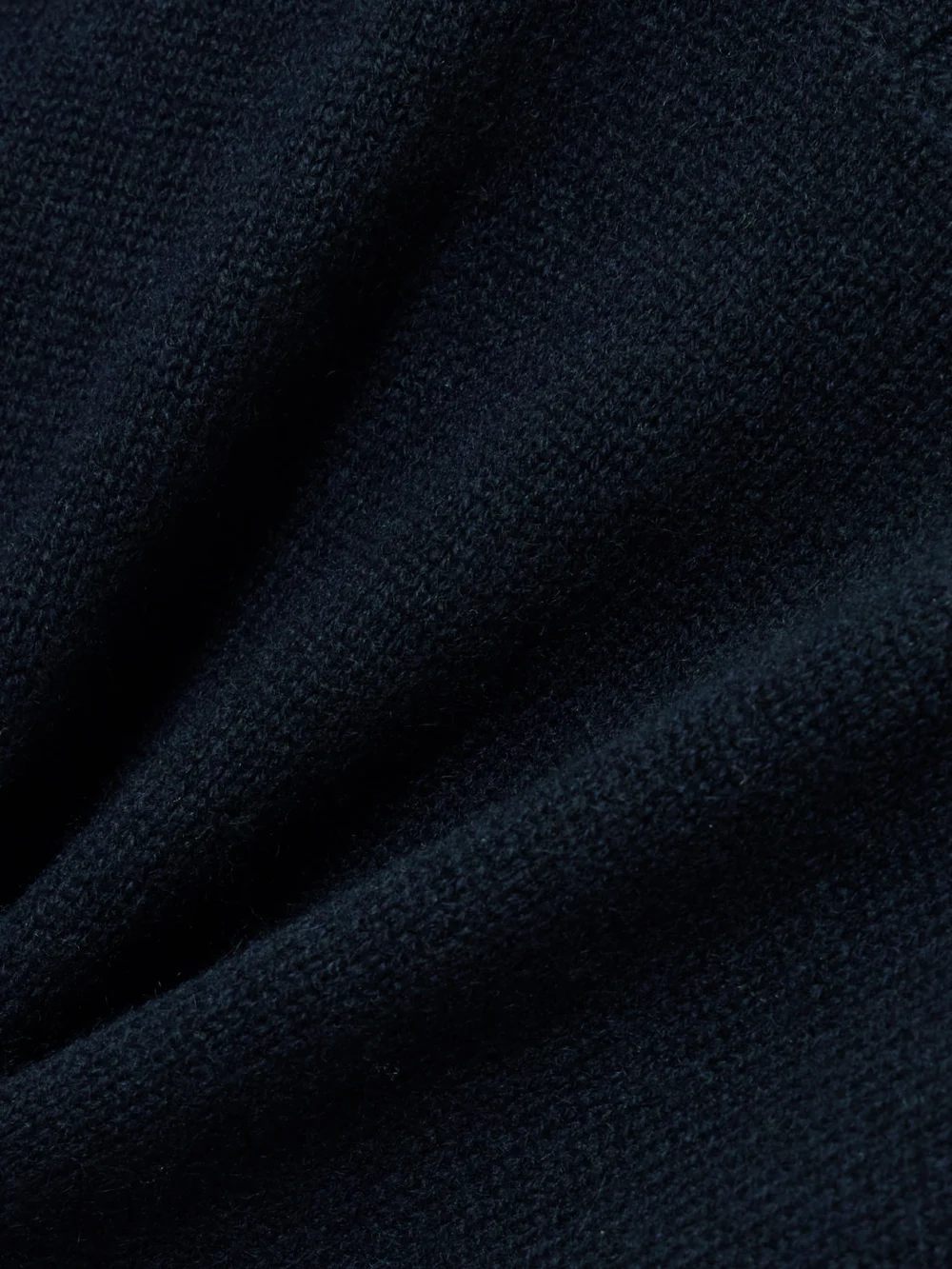 Close-up detail of the Totême Cashmere Turtleneck Sweater