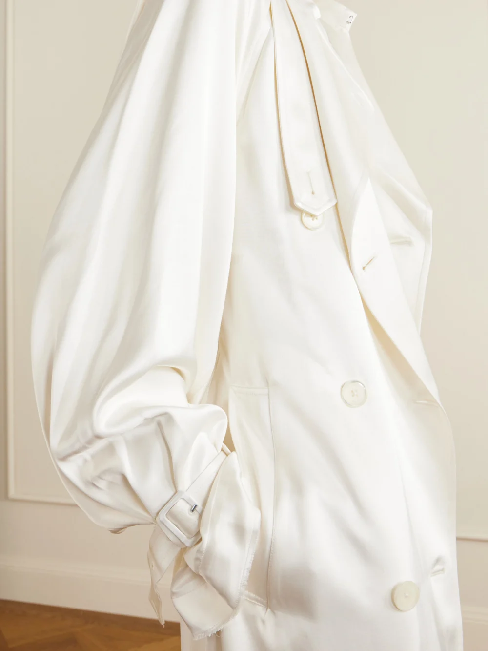 Close-up detail of the Totême Double-breasted Draped Satin Trench Coat