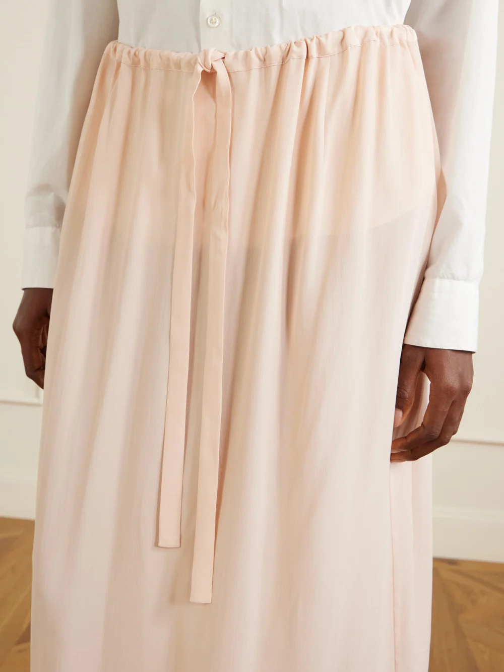 Close-up detail of the Totême Silk Midi Skirt