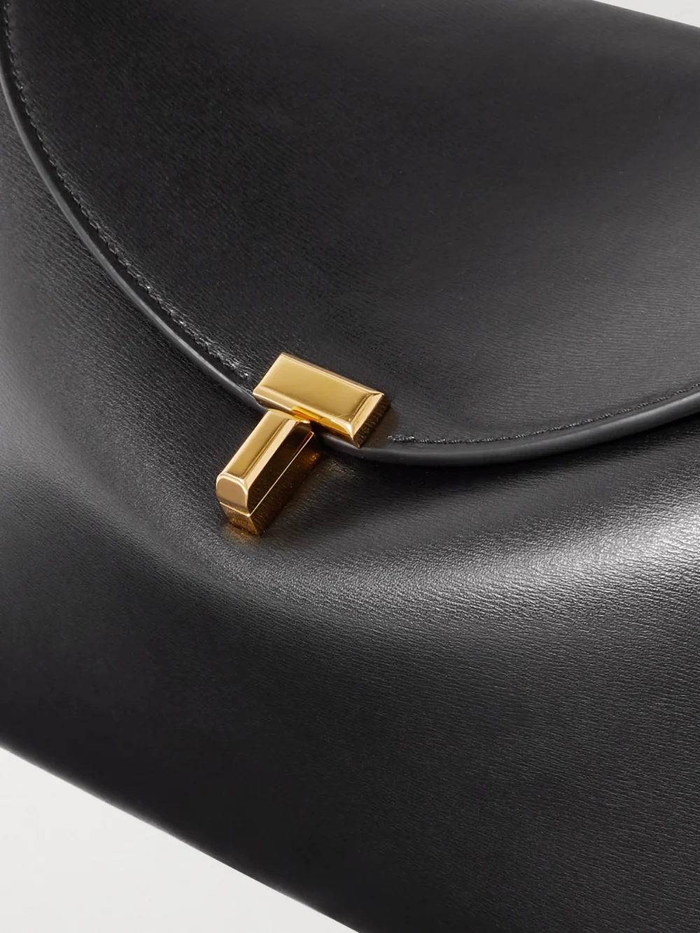 Close-up detail of the Totême T-lock Leather Shoulder Bag