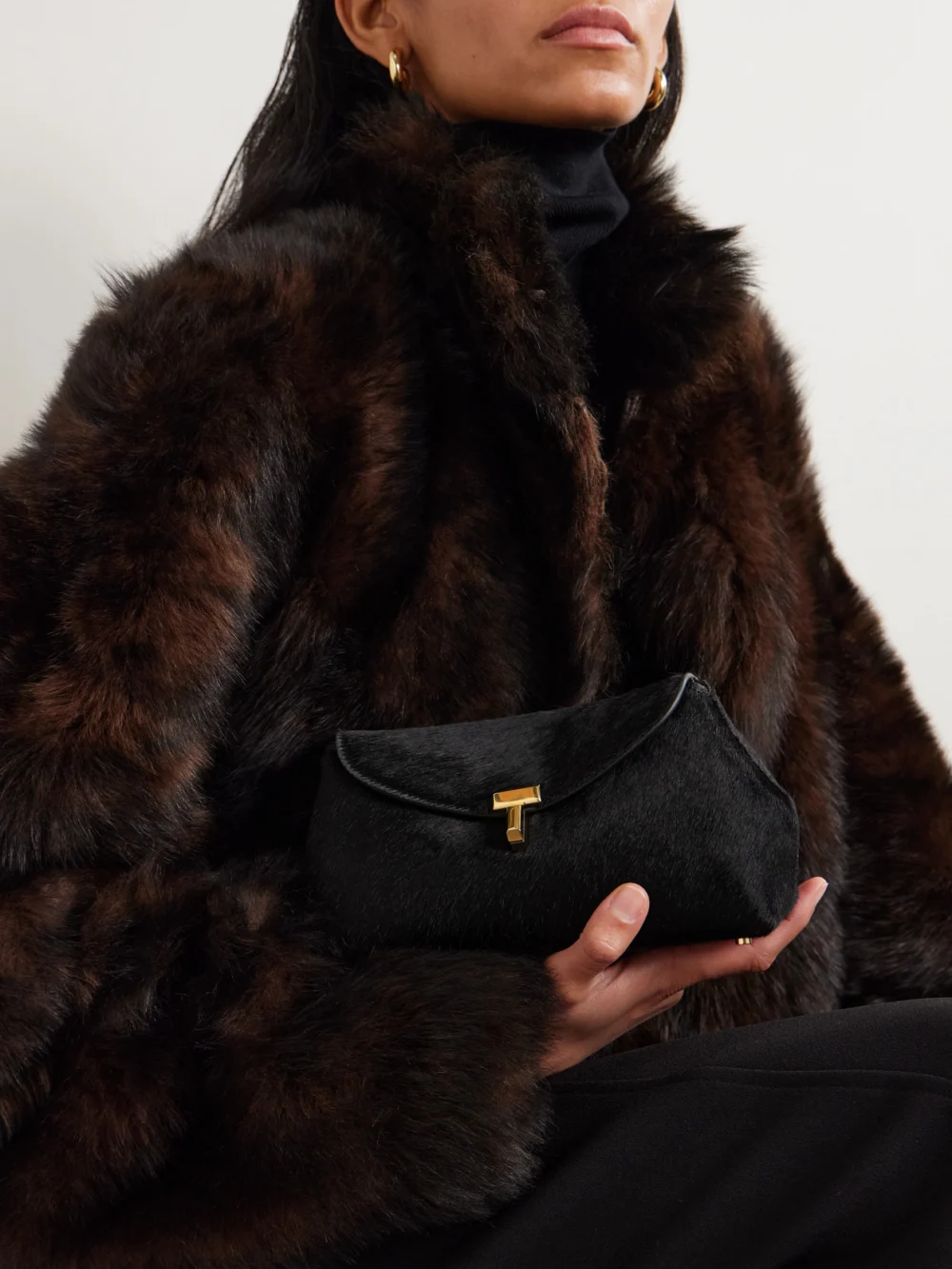 Totême T-lock Mini Calf Hair Clutch, styled view
