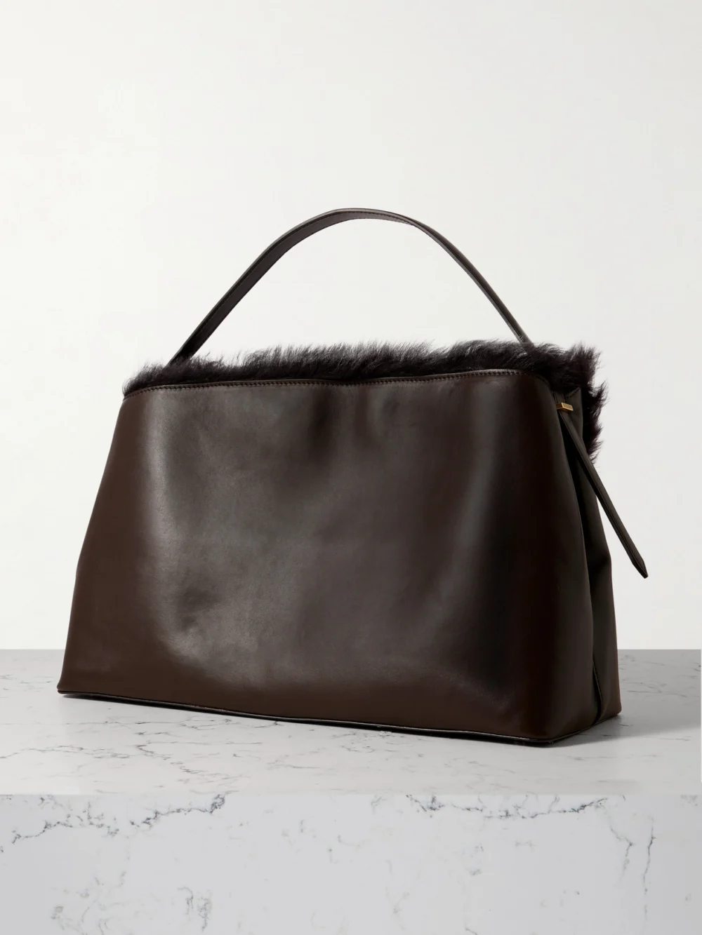 Back view of the Totême T-lock Shearling Shoulder Bag