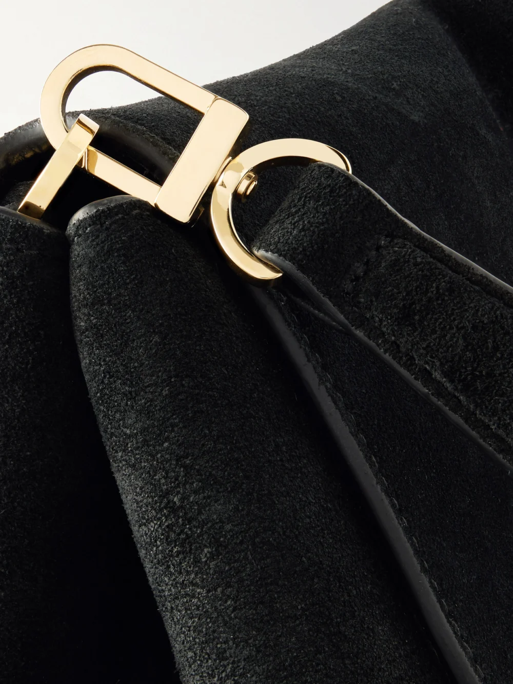 Close-up detail of the Totême T-lock Suede Shoulder Bag