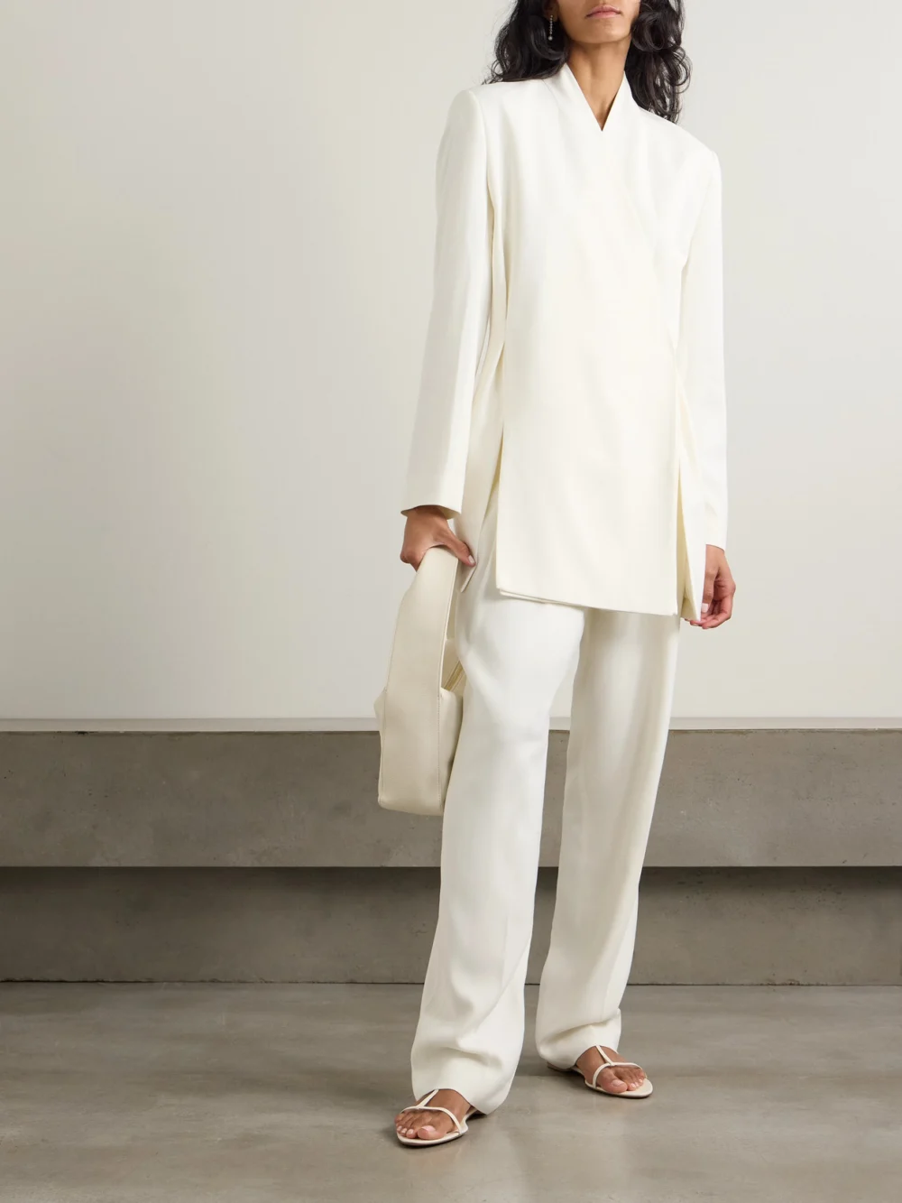 Tove Emery Pleated Crepe Straight-leg Pants, worn by a model