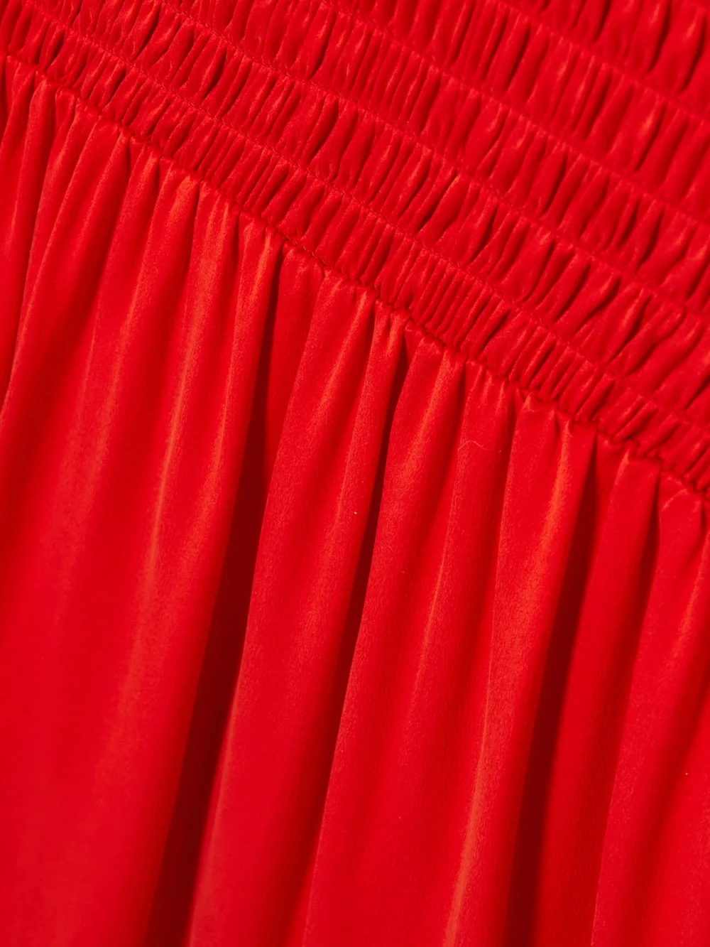 Close-up detail of the Tove Mahaney Gathered Smocked Silk Midi Dress