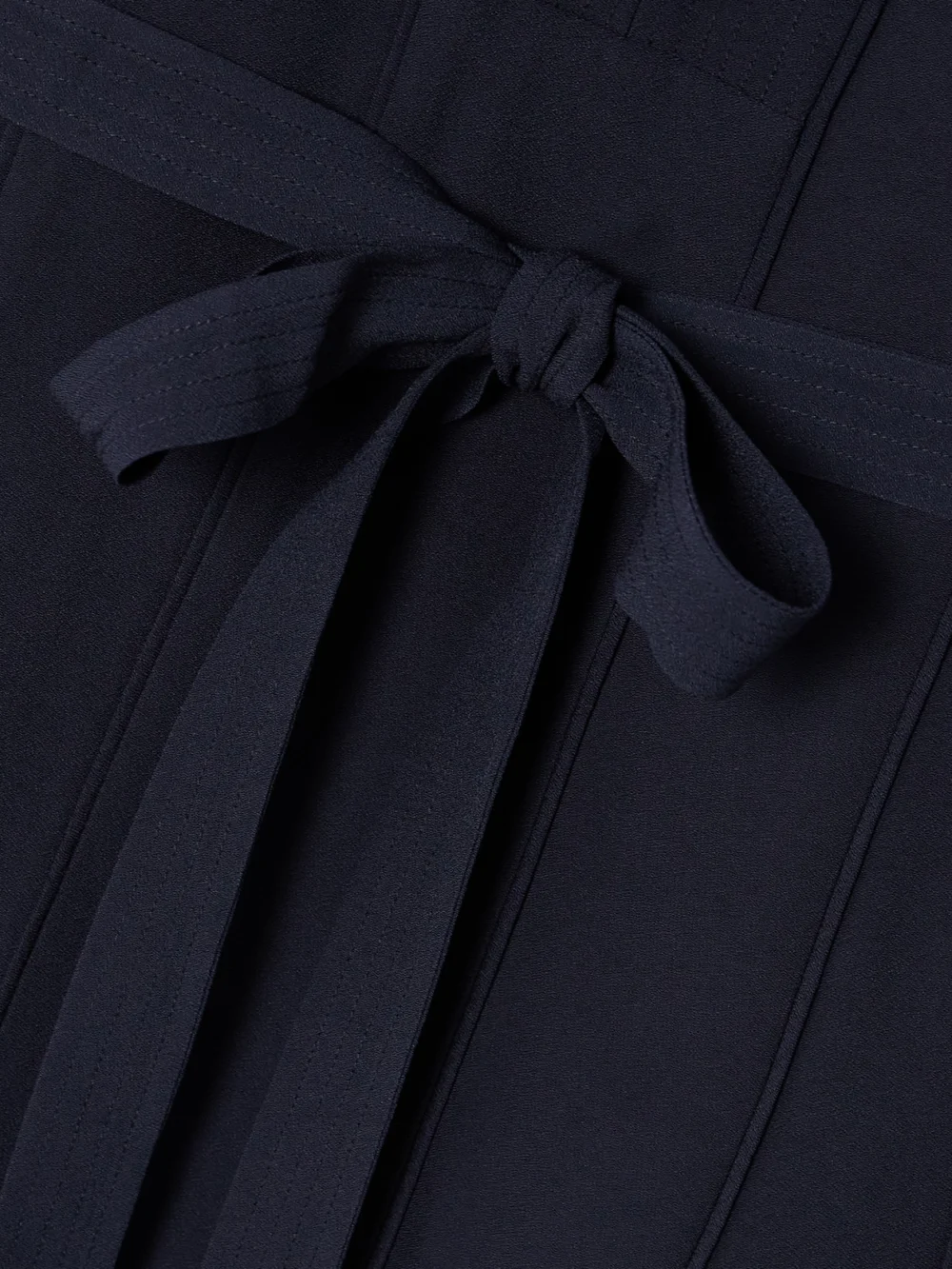 Close-up detail of the Ulla Johnson Asilia Belted Crepe Midi Dress