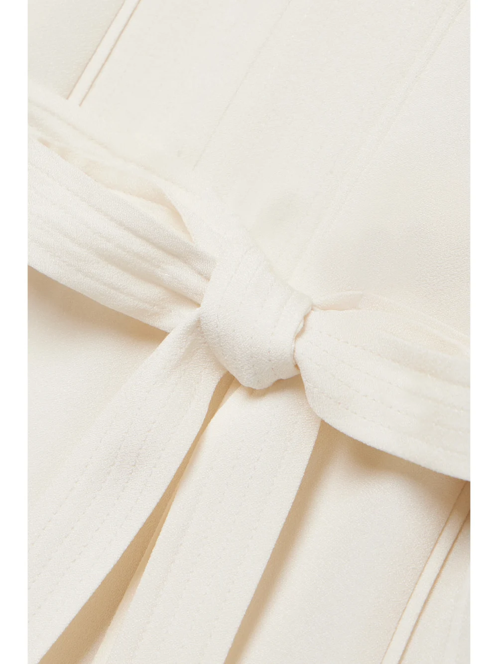 Close-up detail of the Ulla Johnson Daisy Belted Paneled Crepe Mini Dress