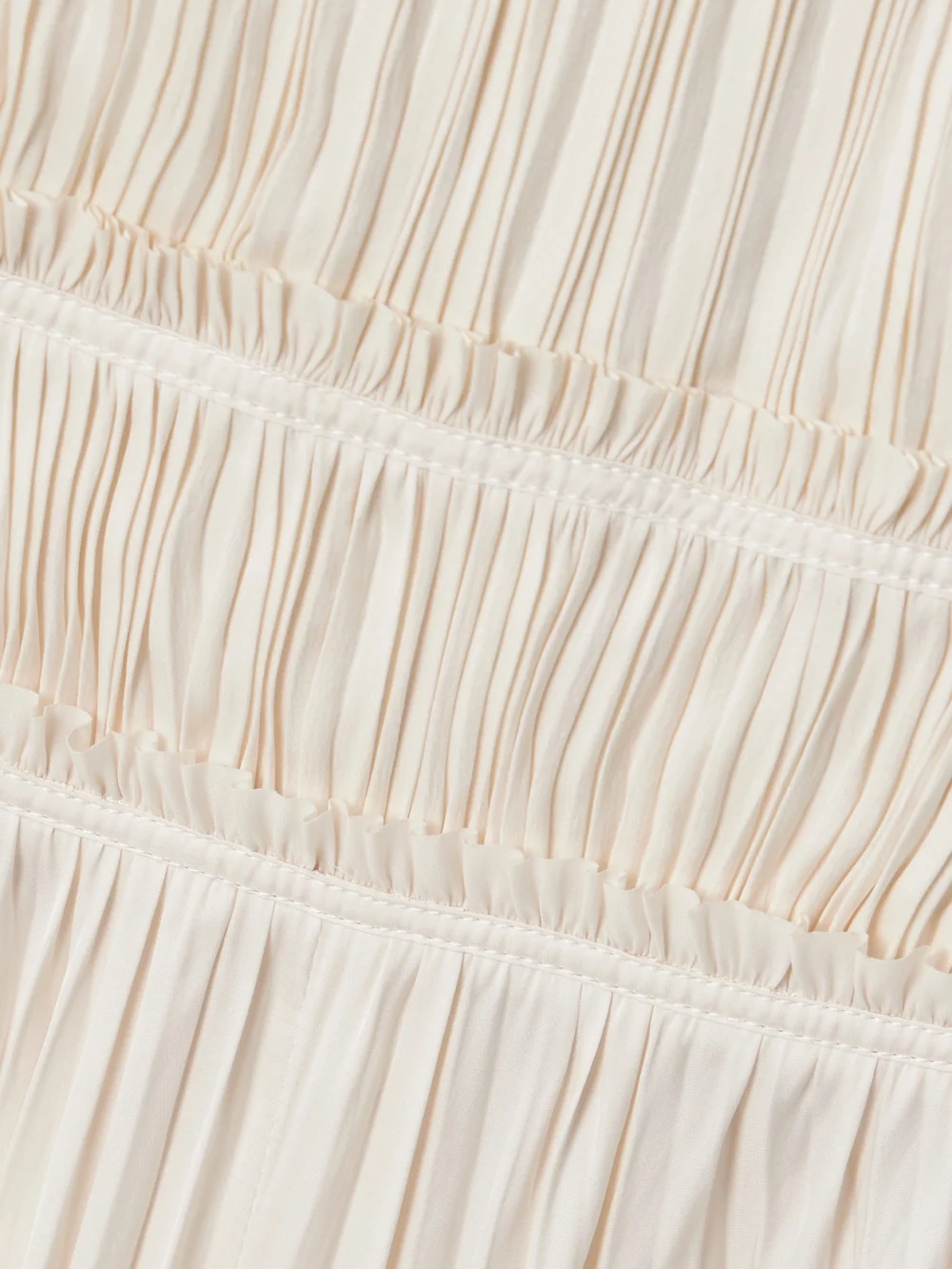 Close-up detail of the Ulla Johnson Elle Paneled Plissé-satin Midi Dress