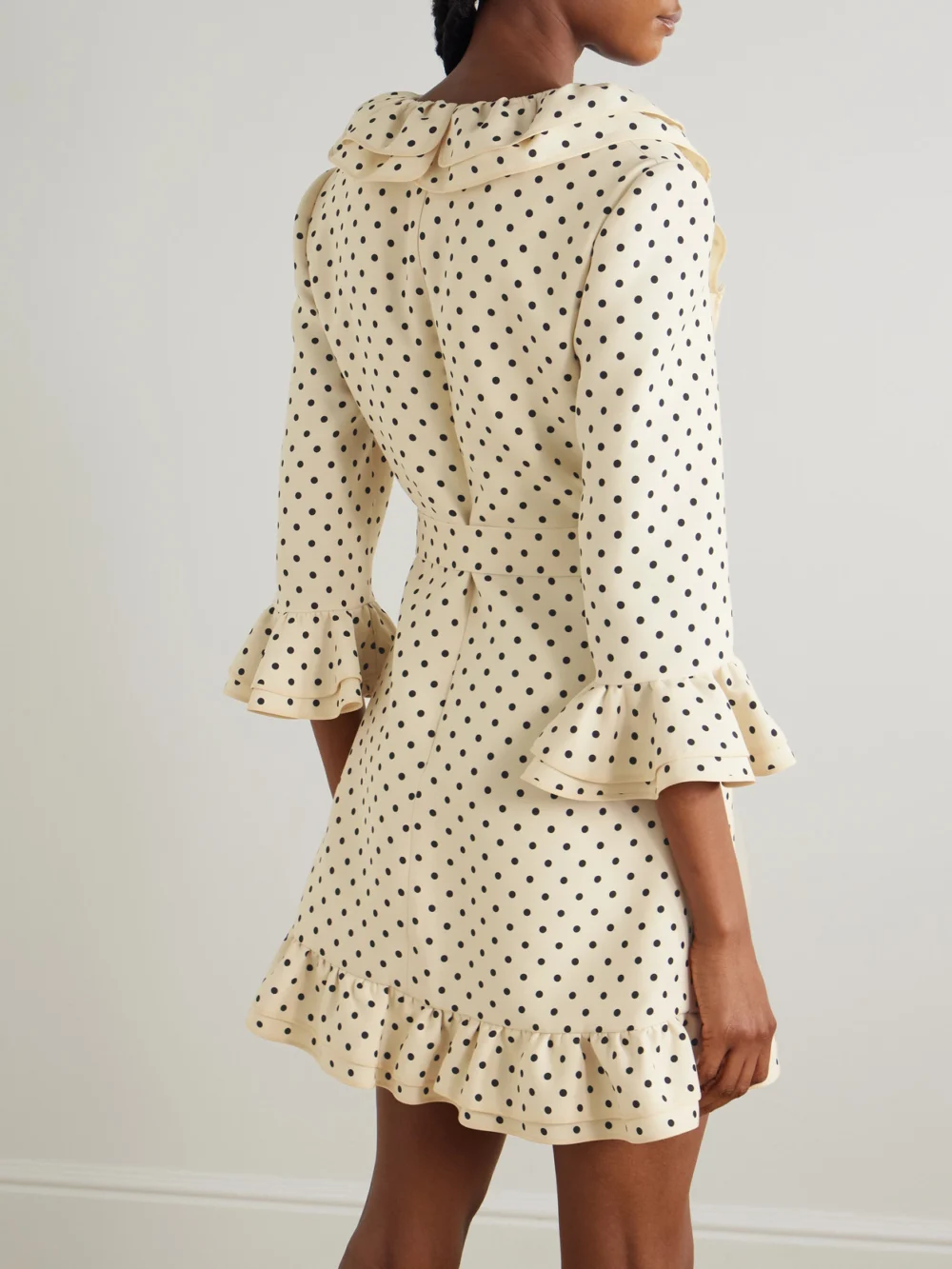 Back view of the Valentino Garavani Belted Ruffled Polka-dot Wool and Silk-blend Mini Dress