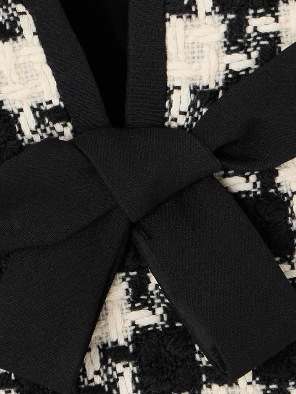 Close-up detail of the Valentino Garavani Bow-embellished Crepe-trimmed Checked Tweed Mini Dress