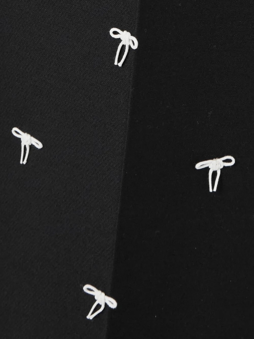 Close-up detail of the Valentino Garavani Bow-embellished Wool and Silk-blend Twill Wide-leg Pants