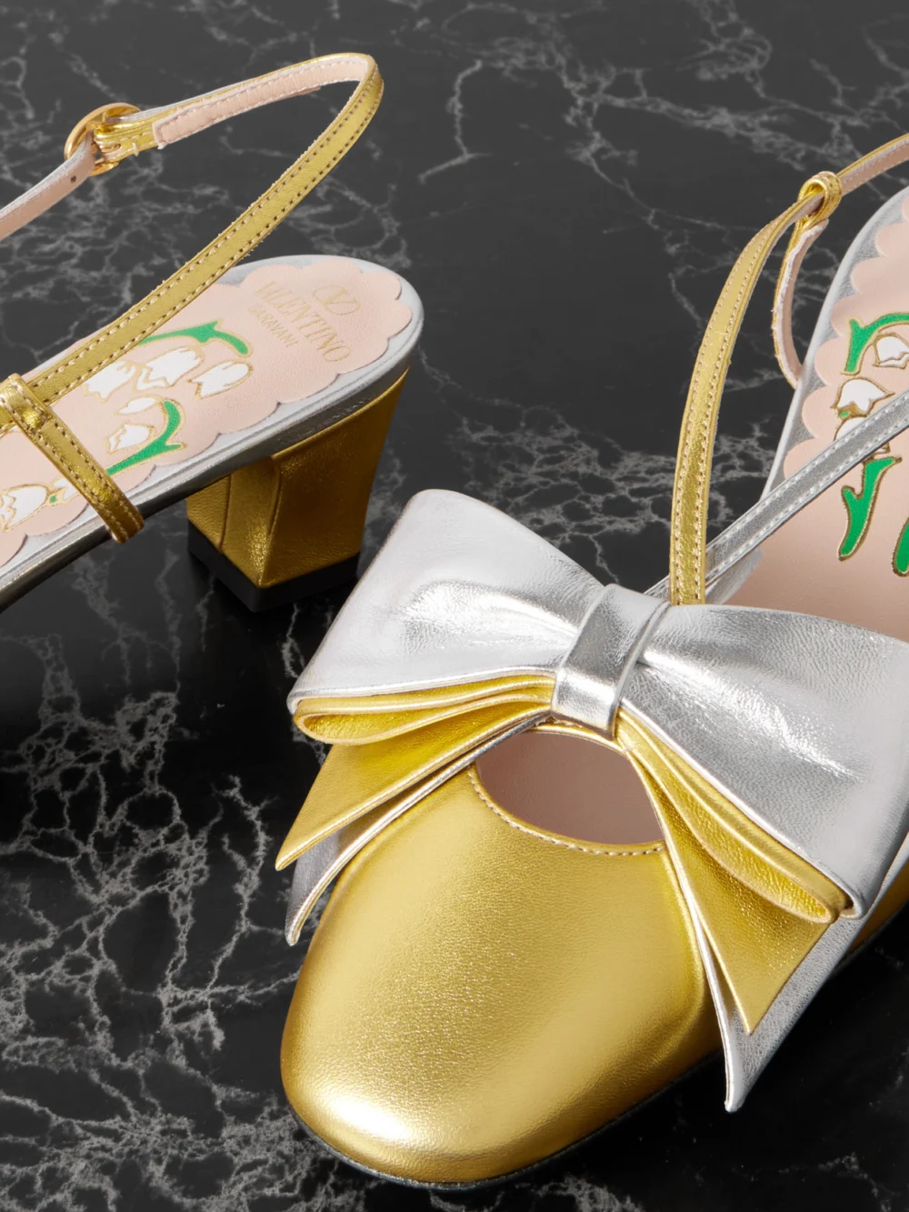 Close-up detail of the Valentino Garavani Bowbow Two-tone Metallic Leather Pumps
