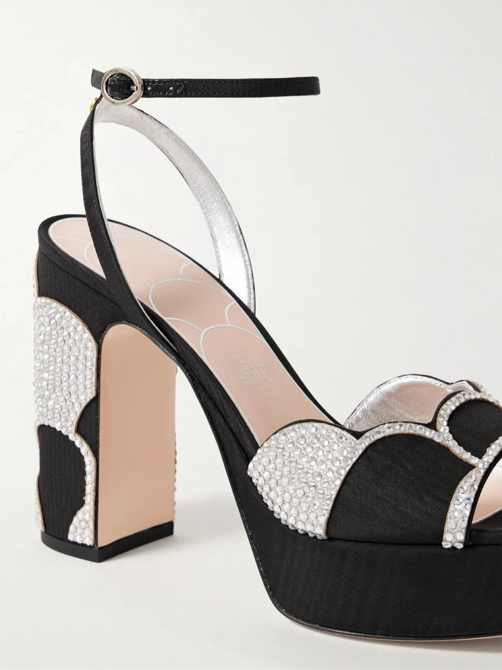 Close-up detail of the Valentino Garavani Bowow 110 Faille and Crystal-embellished Metallic Leather Platform Sandals
