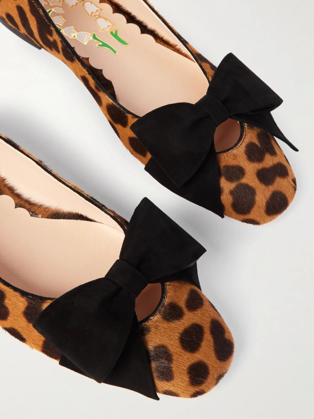 Close-up detail of the Valentino Garavani Bowow Suede-trimmed Leopard-print Calf Hair Ballet Flats