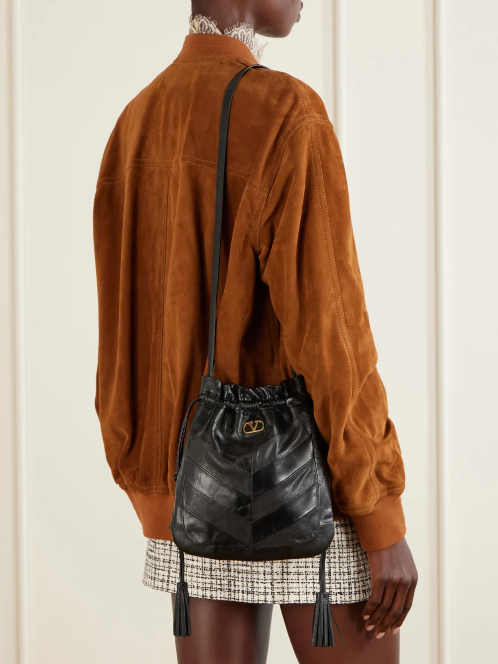 Valentino Garavani Buckette Logo-embellished Drawstring Leather Shoulder Bag, styled view
