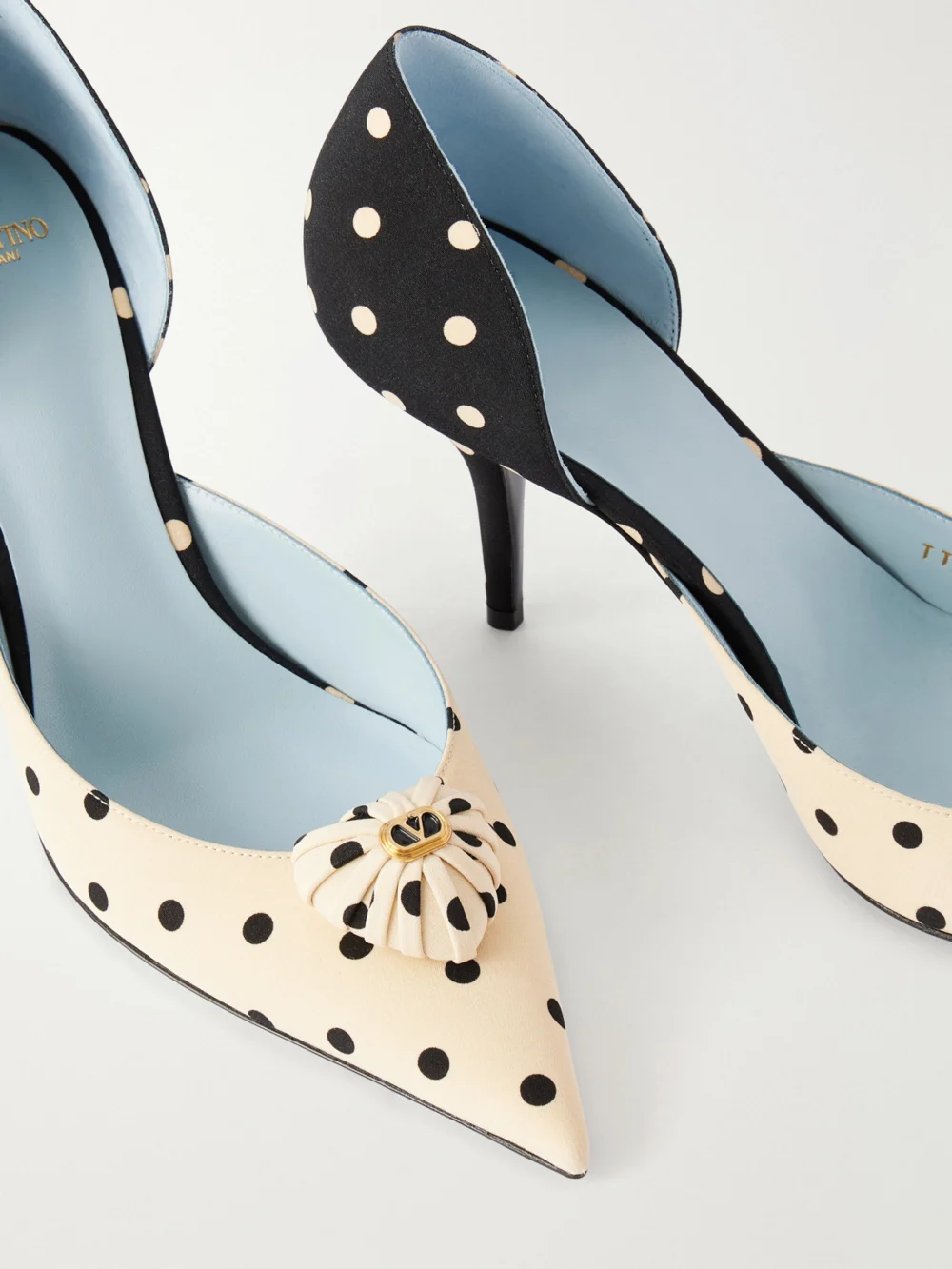 Close-up detail of the Valentino Garavani Coeur D'orsay 85 Logo-embellished Polka-dot Satin Pumps