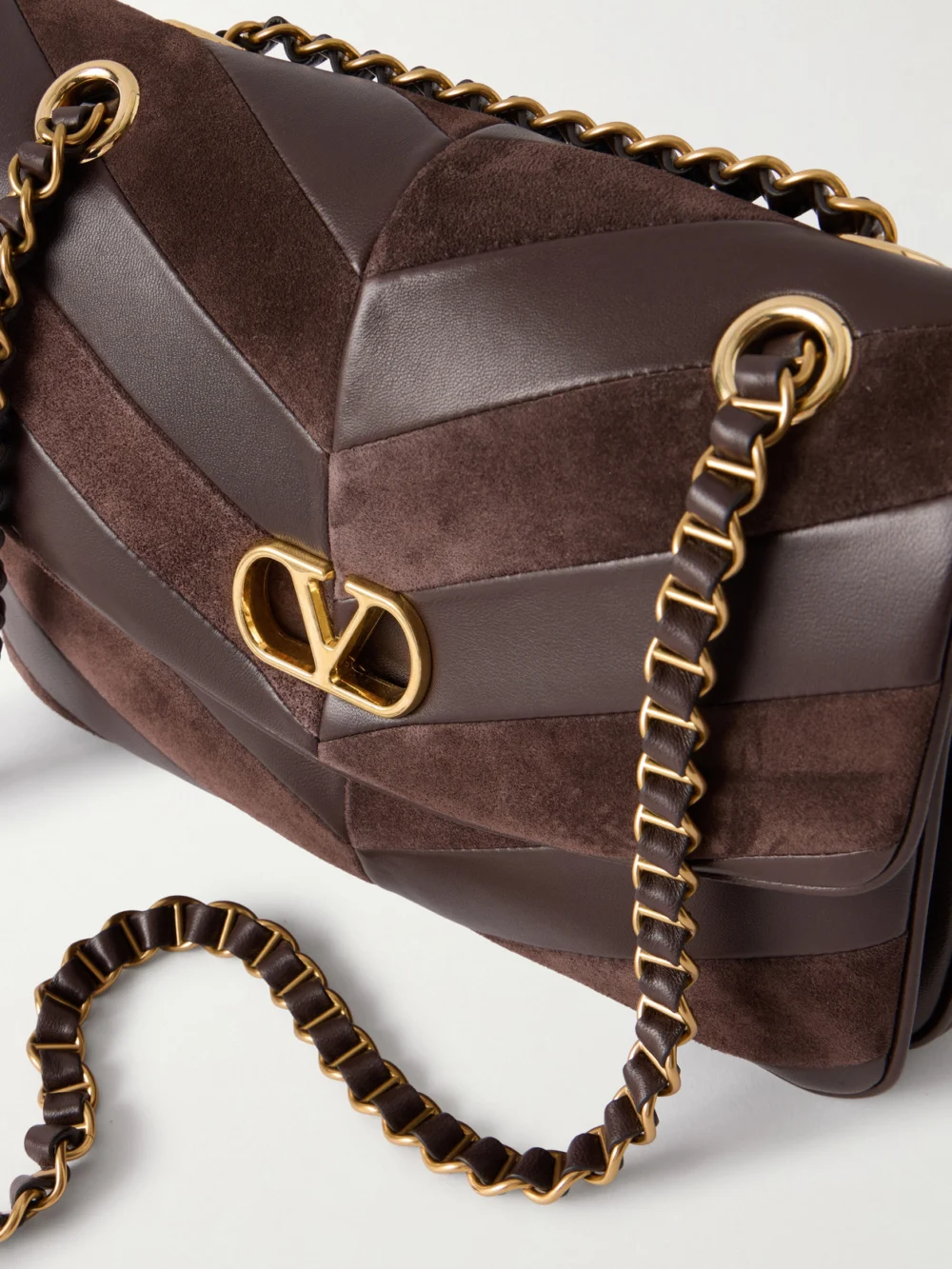 Close-up detail of the Valentino Garavani Djuna Medium Embellished Suede and Leather Shoulder Bag