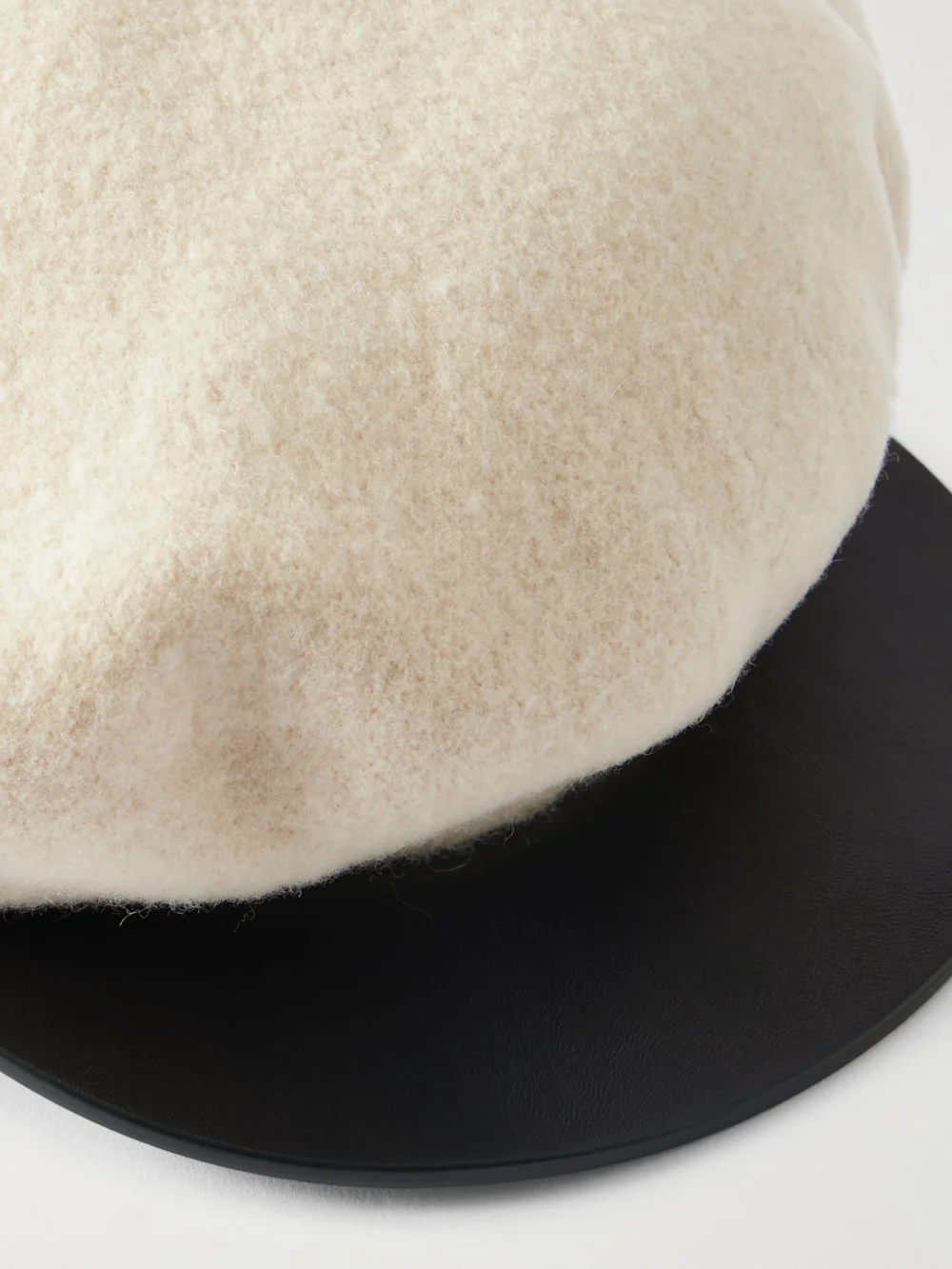 Close-up detail of the Valentino Garavani Embellished Leather-trimmed Wool Cap